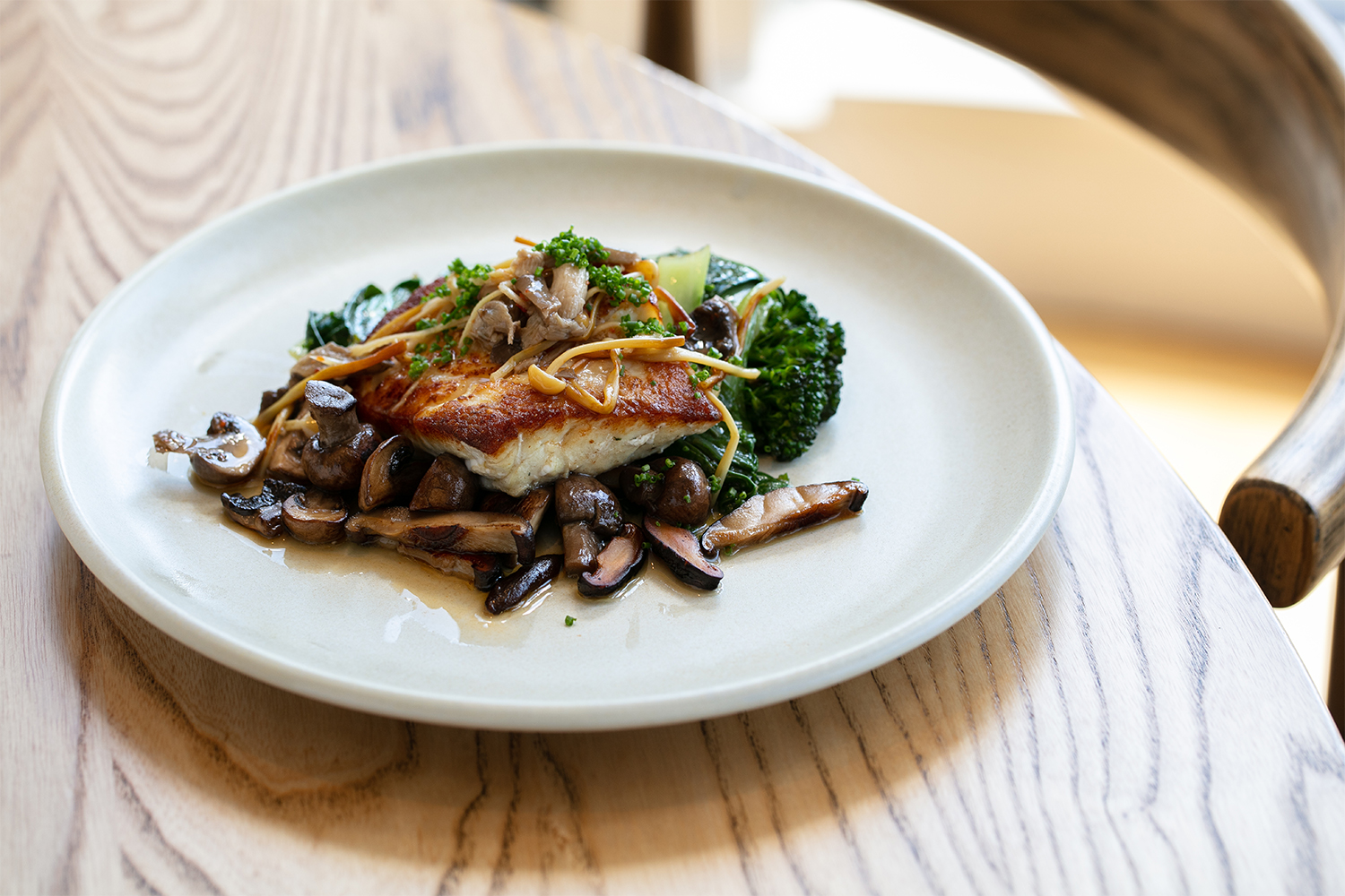 Fish with mushrooms, broccolini and bok choy. Photo / Babiche Martens