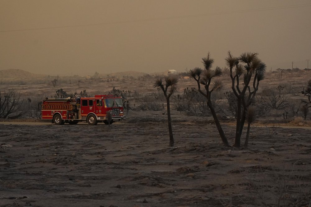 A fire engine is driven through the devastation left behind by the Bobcat Fire on Saturday. Photo / AP