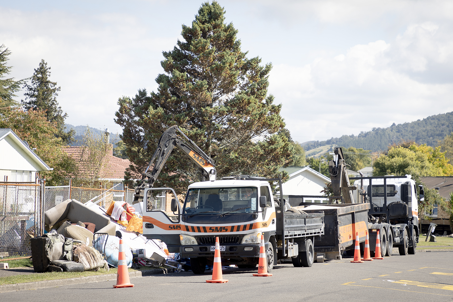 Piles of rubbish being removed from the roadside on Wrigley Rd. Photo / Andrew Warner