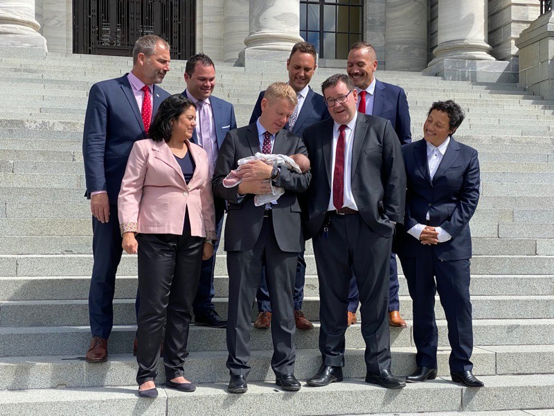 Coffey's daughter Taitimu with Prime Minister Chris Hipkins and colleagues outside Parliament.