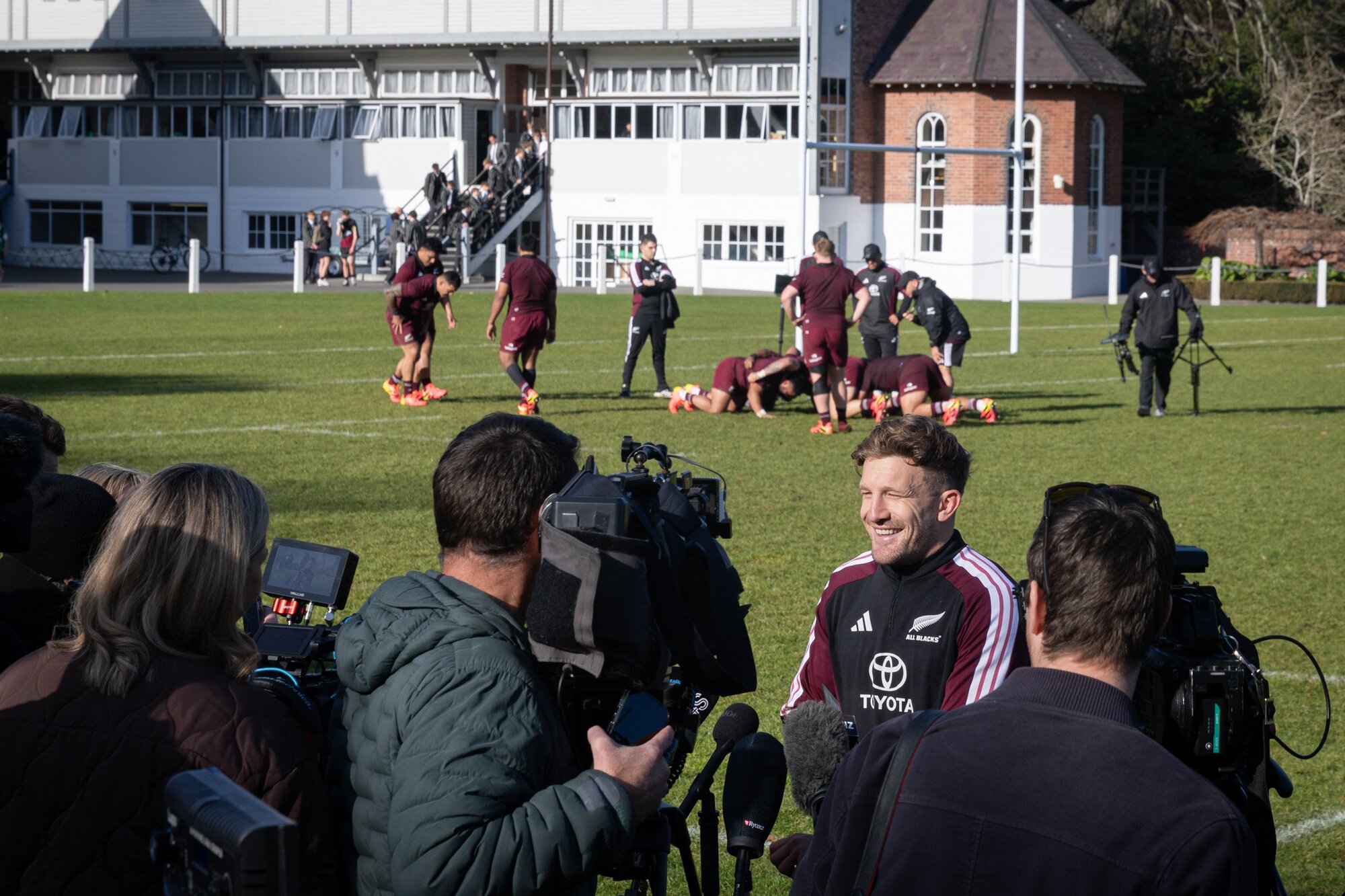 Damian McKenzie talks to the media as the All Blacks forwards get on with training.  Photo / Anna Heath