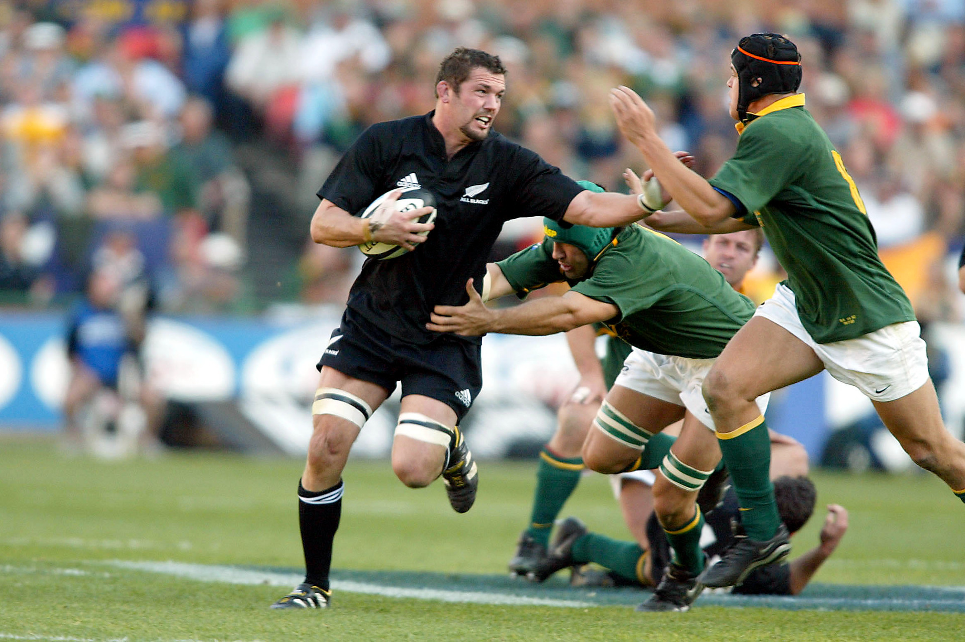 Reuben Thorne fends off Juan Smith as he gets tackled by Victor Matfield. Photo / Photosport