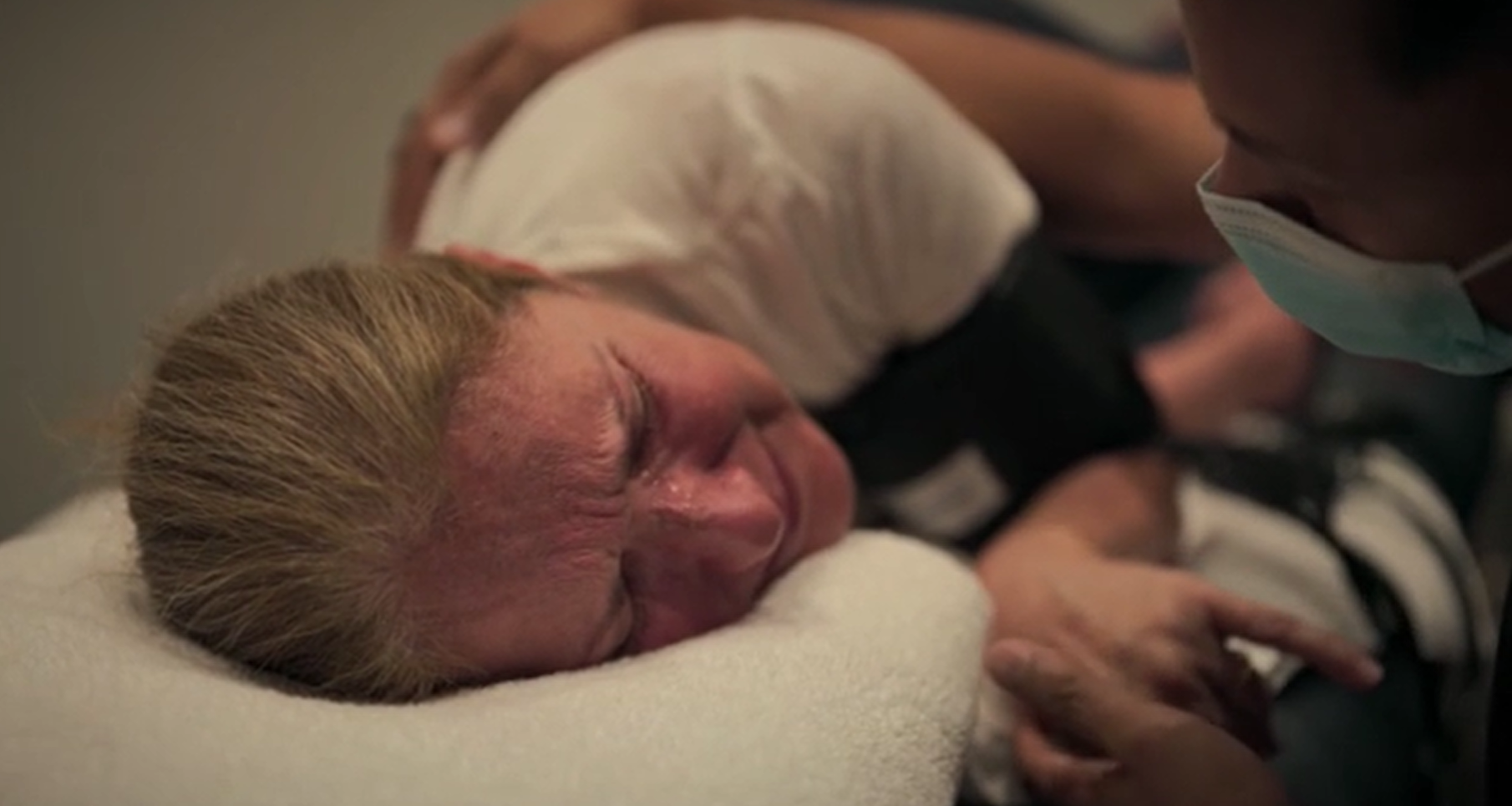 A medical professional squeezes Celine Dion's hand during the unexpected seizure. Photo / Amazon Prime