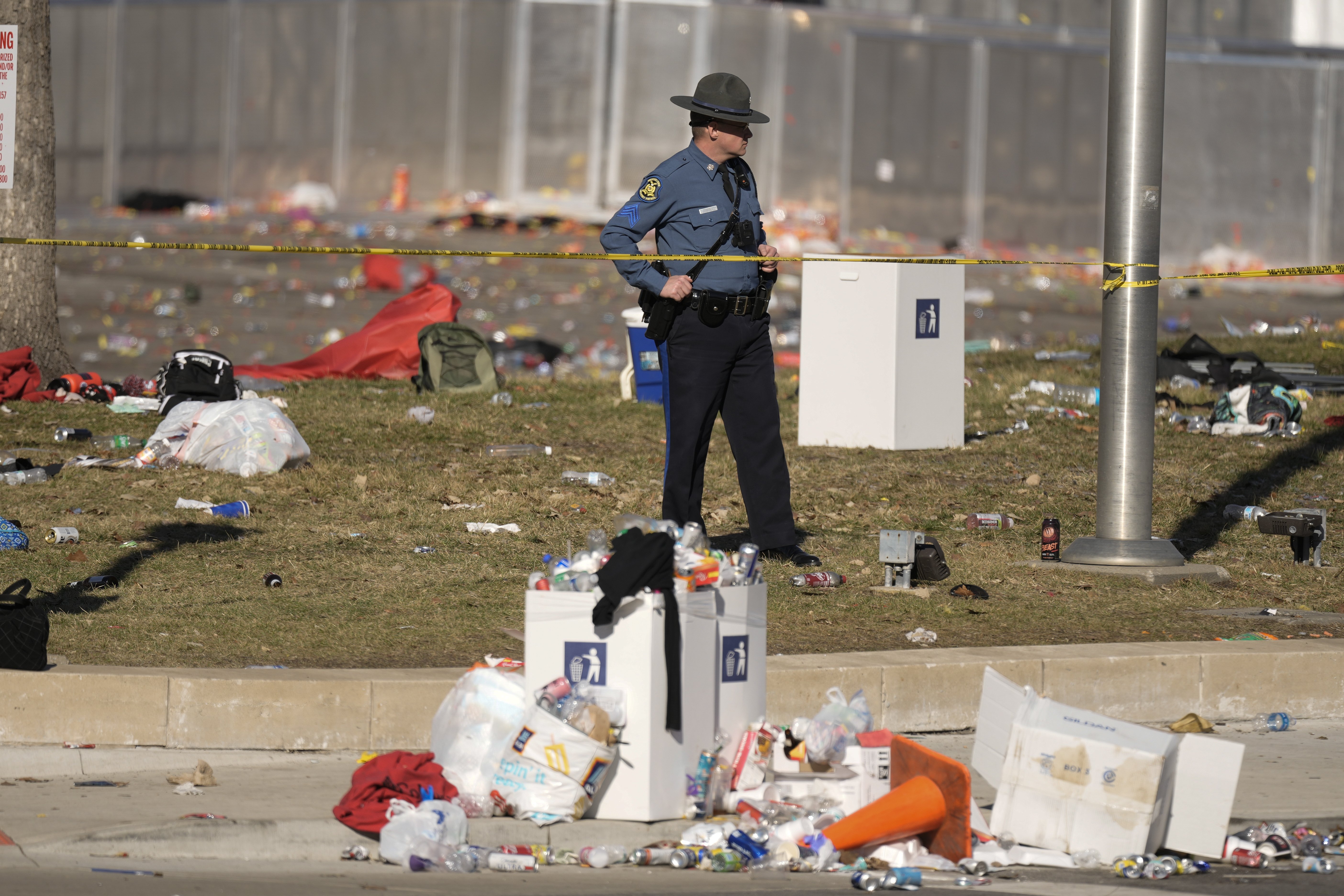A law enforcement officer looks around the scene after an incident following the Kansas City Chiefs victory parade in Kansas City. Photo / AP