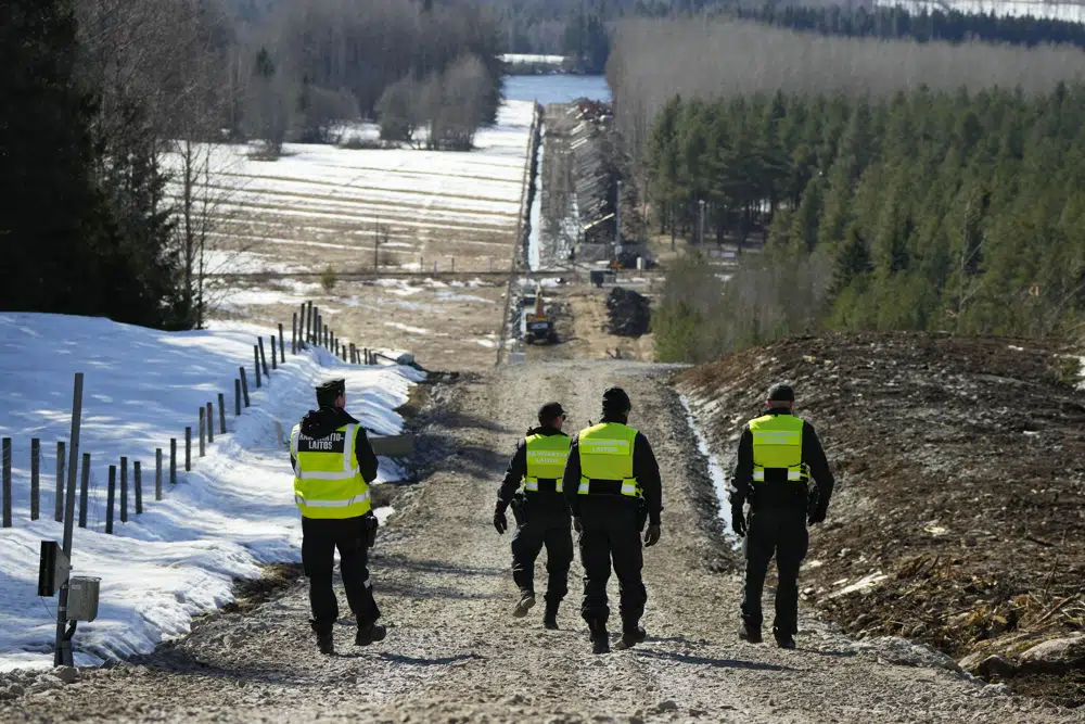 Border guards near the Pelkola border crossing point in Imatra, south-eastern Finland. Photo / AP