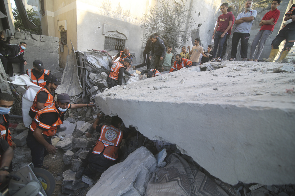 Palestinians search for survivors in the building of the Zanon family, destroyed in Israeli airstrikes in Rafah, Gaza Strip on October 14. Photo / AP