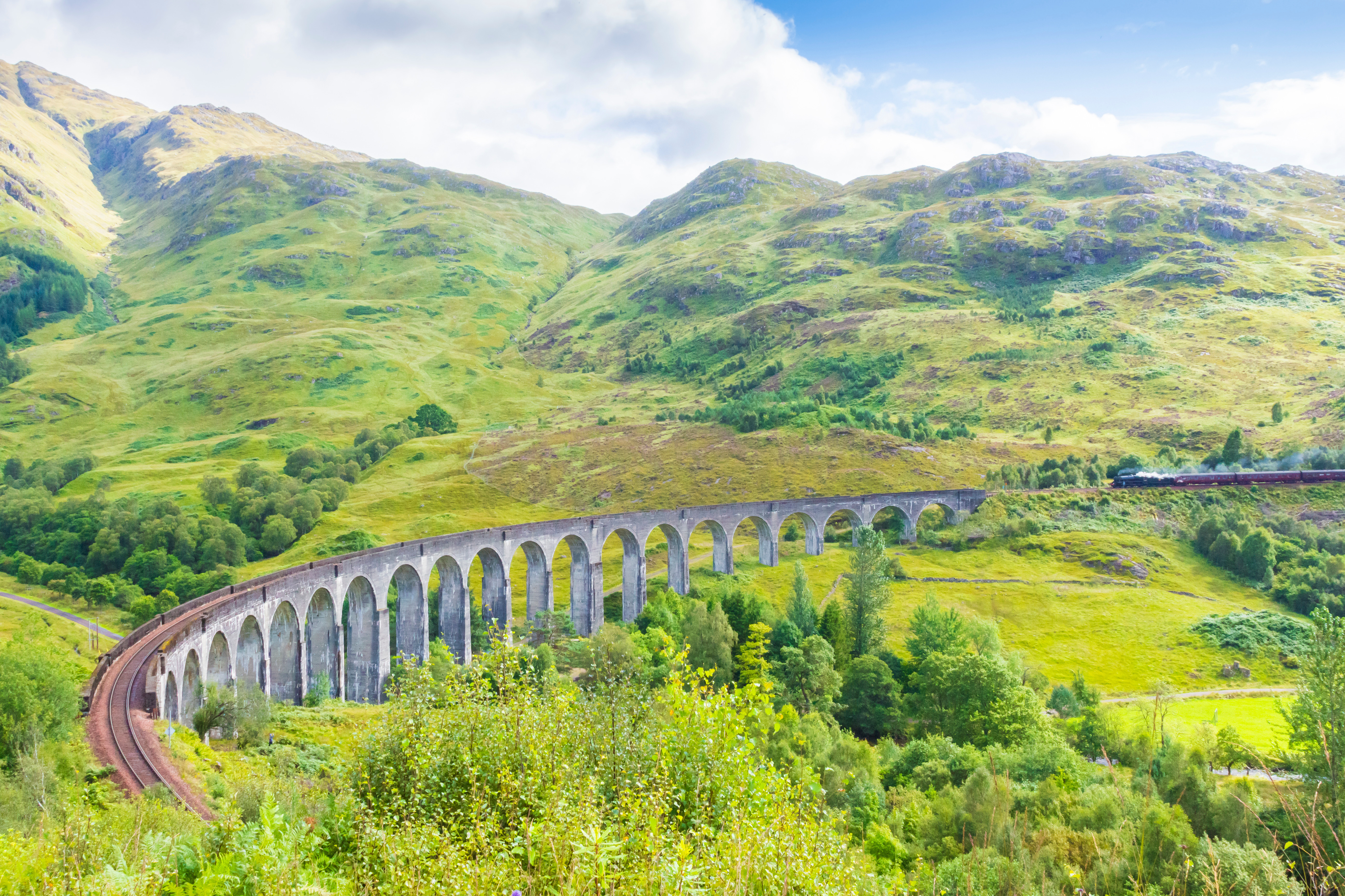 The Harry Potter film series showcased the spellbinding Scottish landscape, with the Jacobite steam train journey passing over the renowned Glenfinnan Viaduct, which made several appearances in the movies. On a clear day, travelers might also catch sight of the Inner Hebridean small isles Rum, Eigg, Muck, and Canna. Photo / Supplied