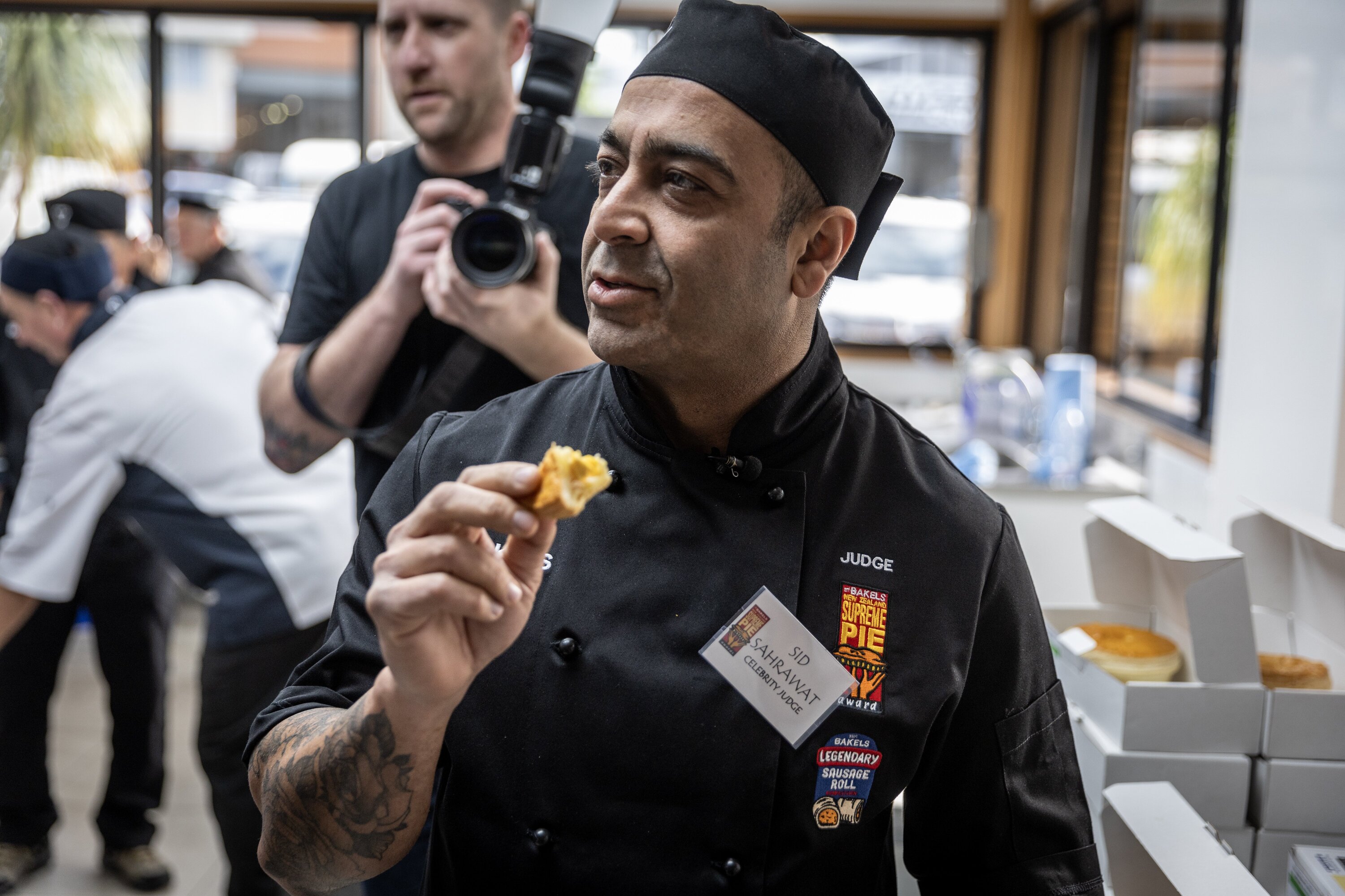 Sid Sahrawat tastes a bacon and egg pie. Photo / Michael Craig