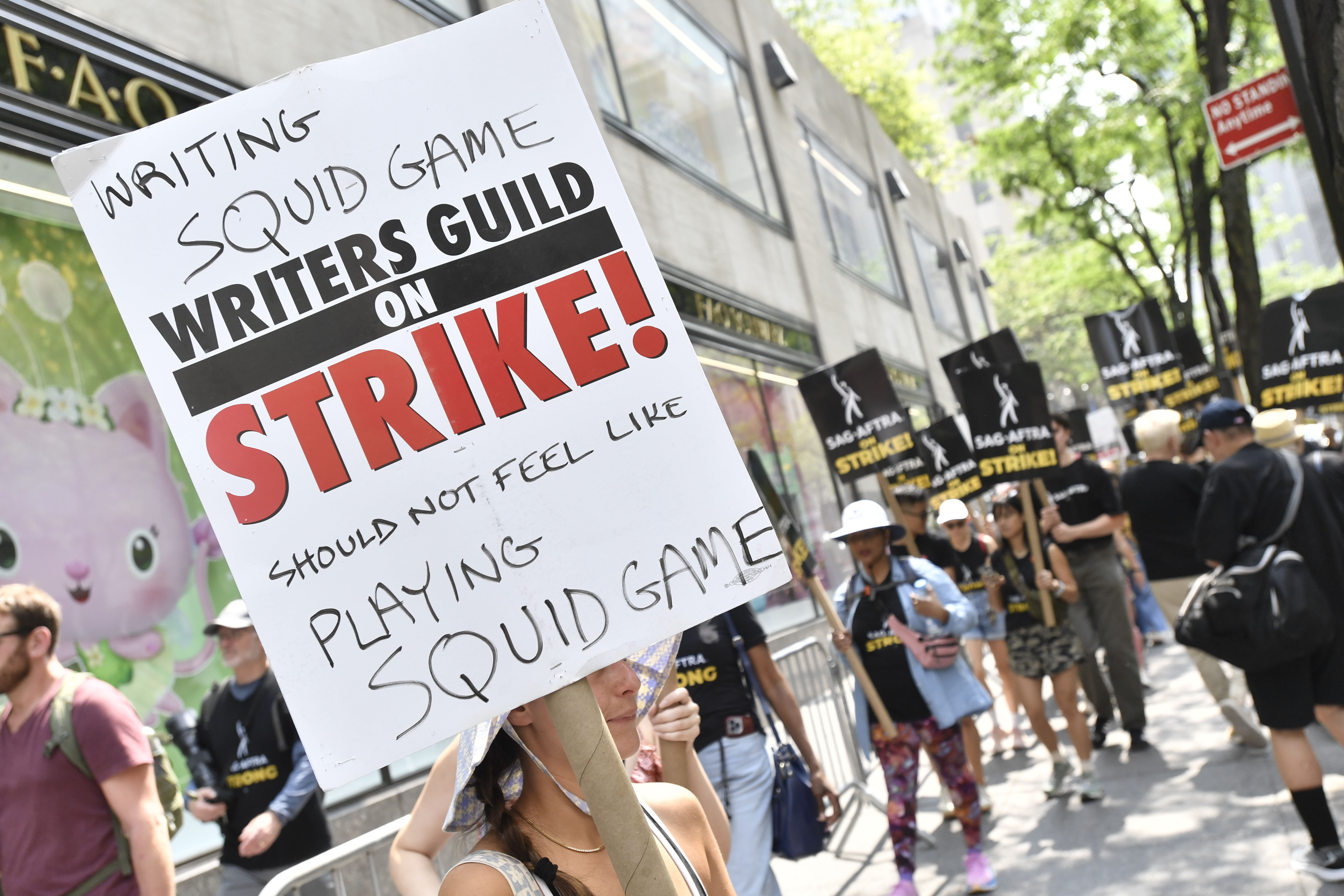 Picketers carry signs outside NBC in Rockefeller Centre on Monday. The actors' strike comes more than two months after screenwriters began striking in their bid to get better pay and working conditions and for clear guidelines around the use of AI in film and television productions. Photo / AP