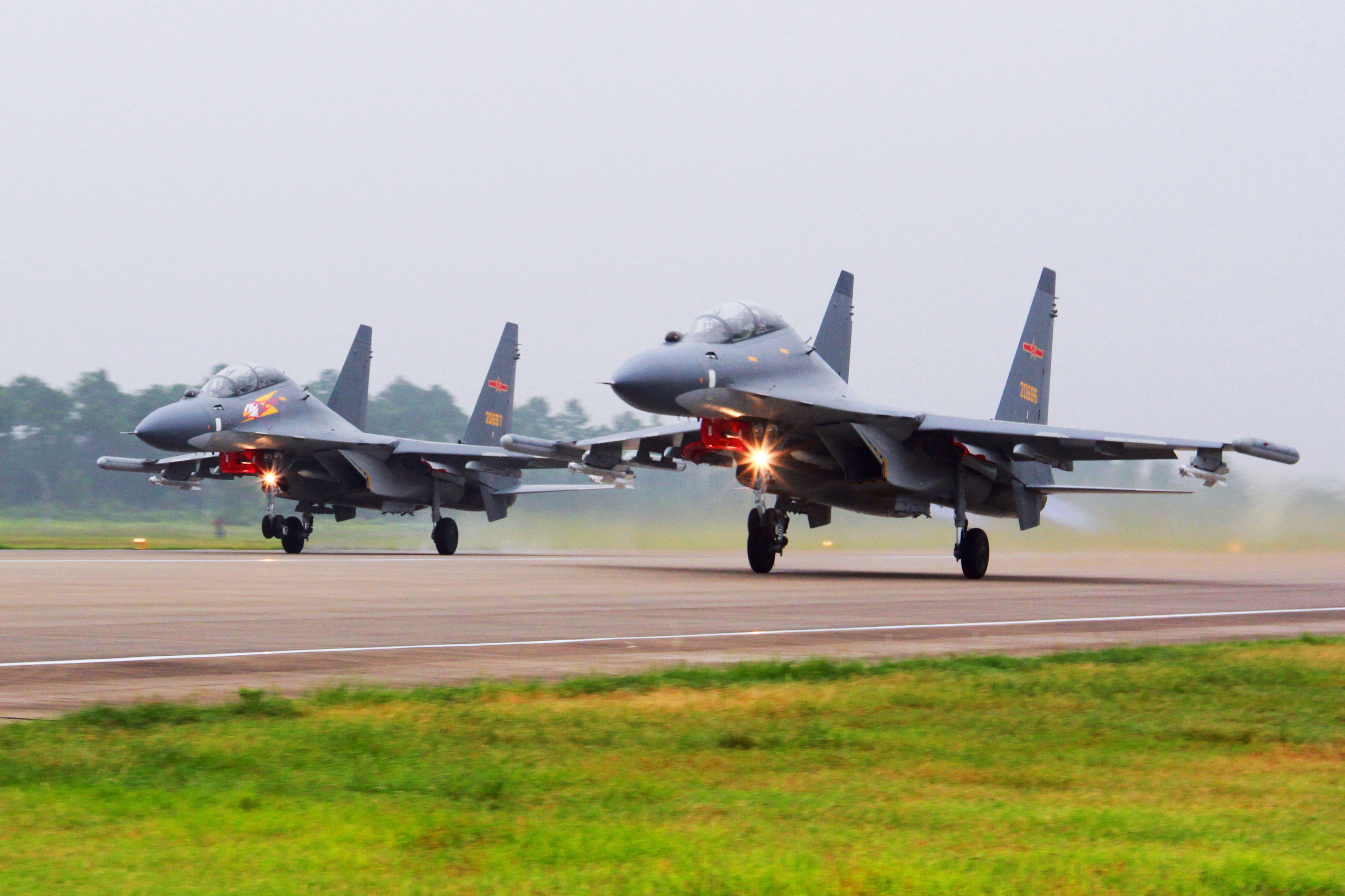 Two Chinese SU-30 fighter jets take off from an unspecified location to fly a patrol over the South China Sea. Photo / AP