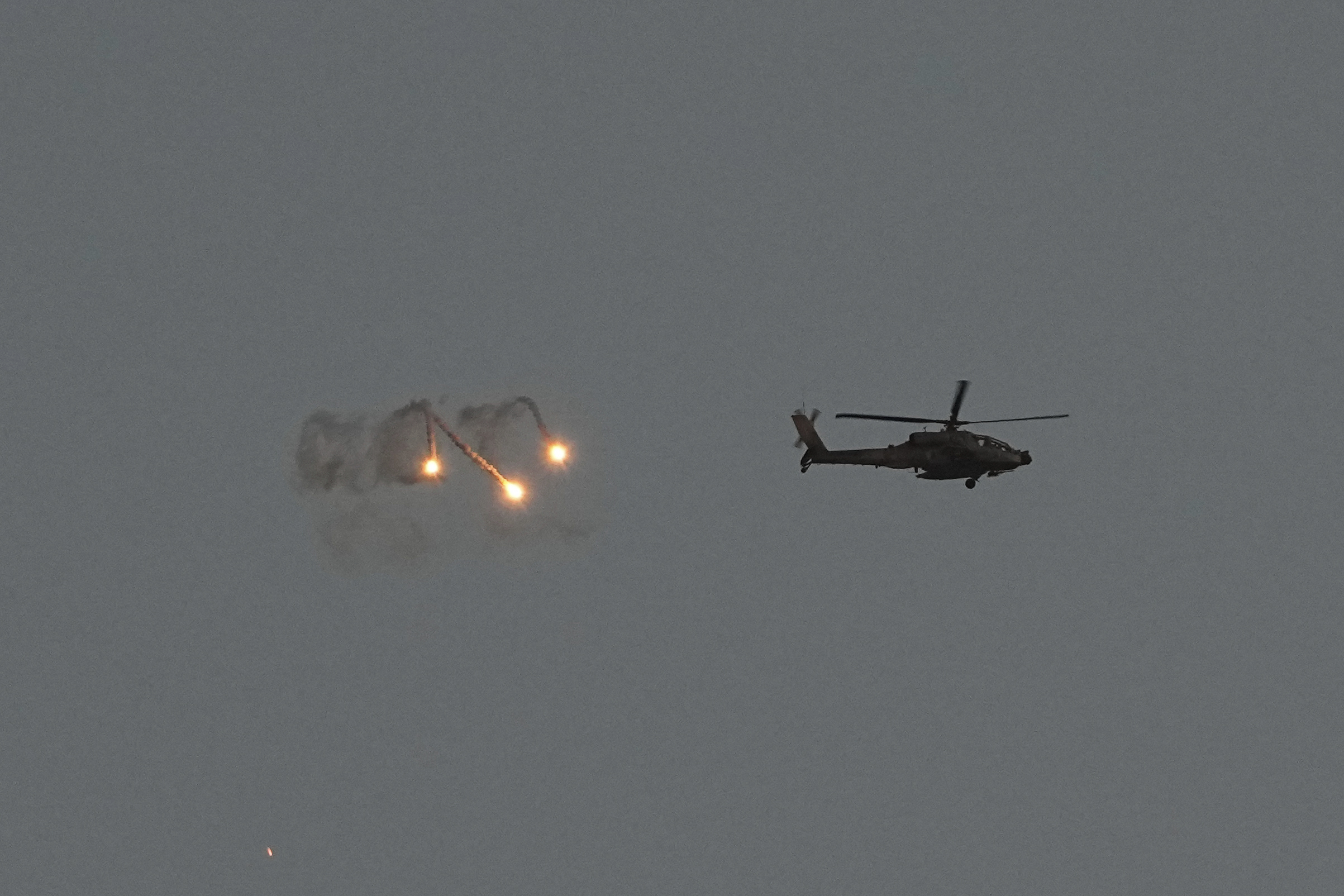 An Israeli Apache helicopter fires flares over the Gaza Strip. Photo / AP