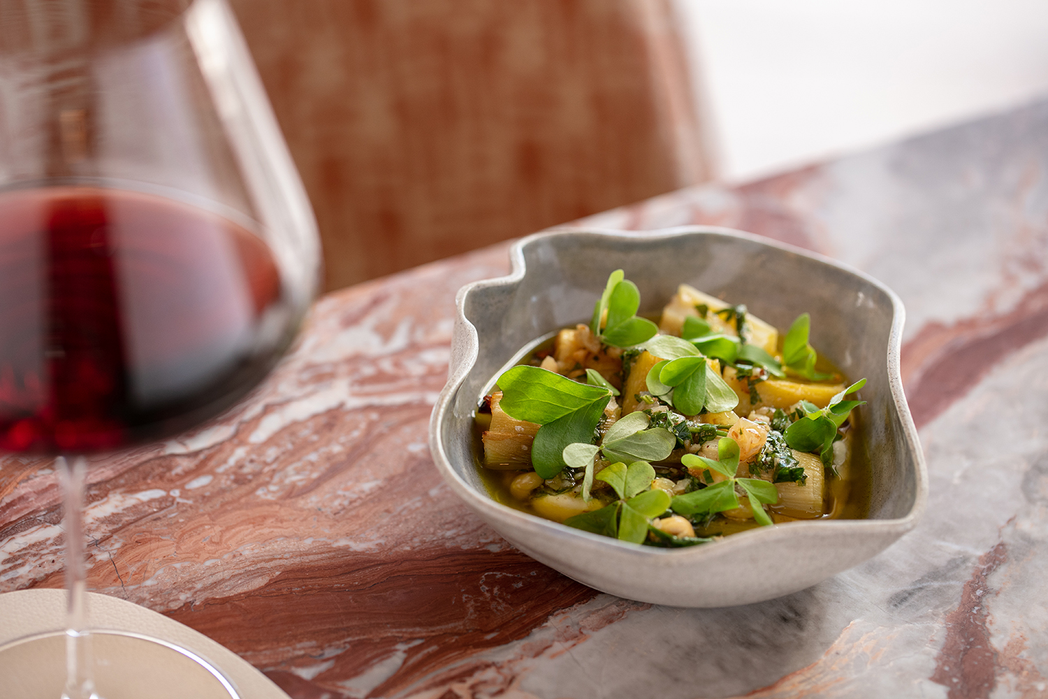 The leeks, with raisins, hazelnuts and a smoked tofu cream. Photo / Babiche Martens