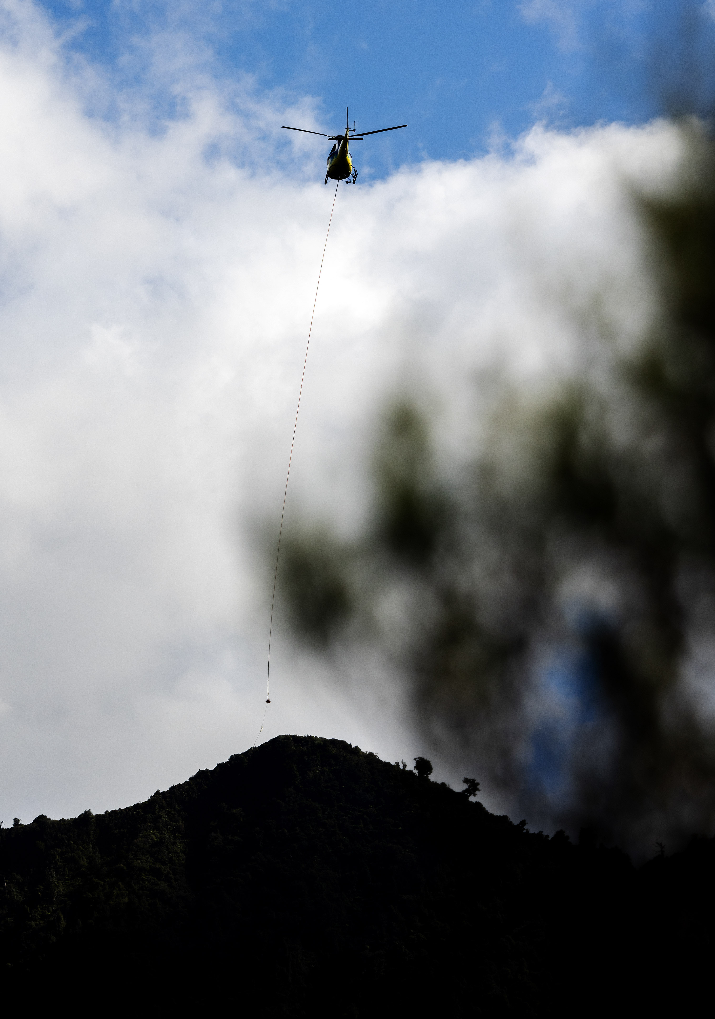 A helicopter aiding exploratory drilling by mining company OceanaGold on DoC land in the Coromandel, photographed by the Herald at the top of the Wharekirauponga Track. Photo / Mike Scott