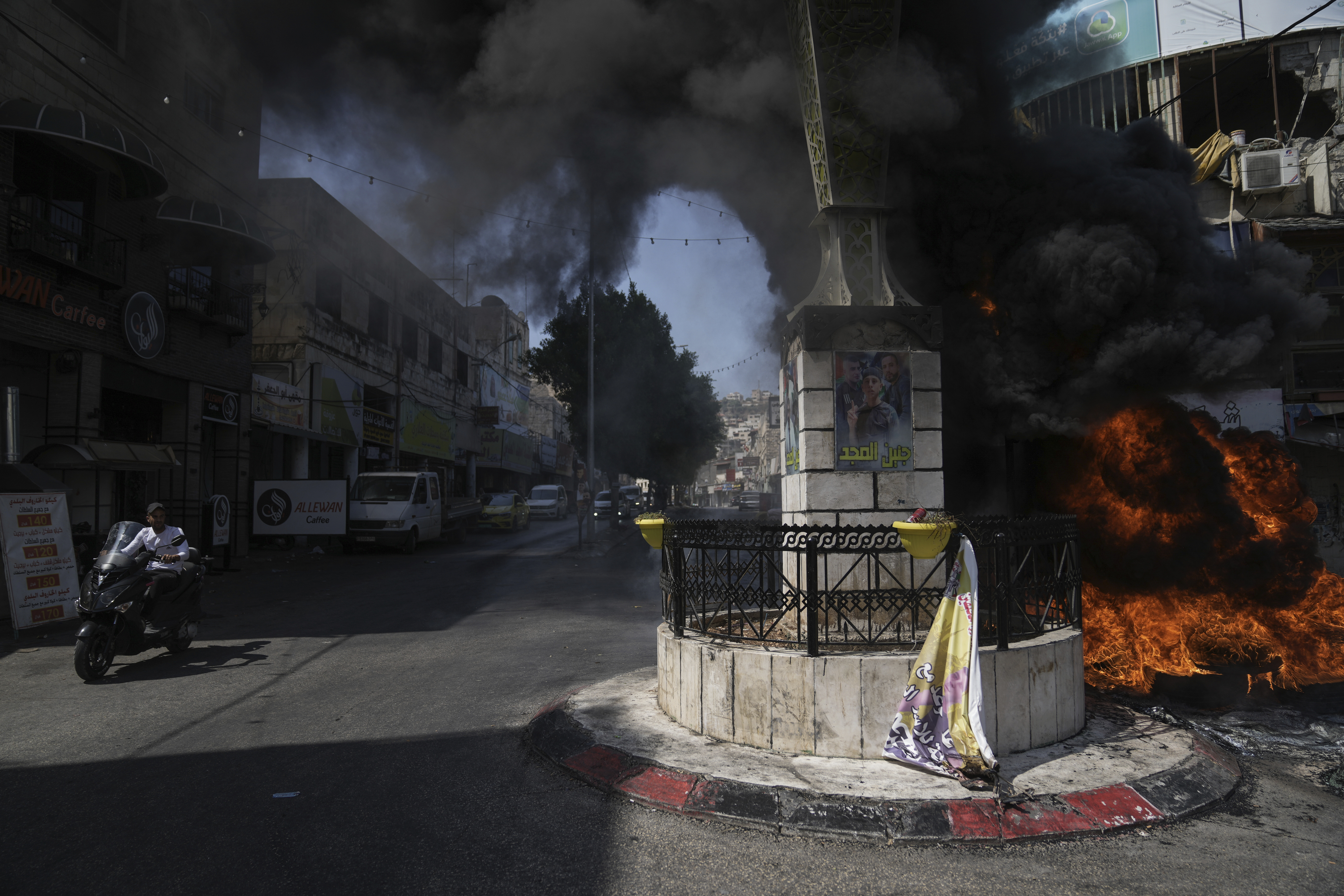 Tires burn in the militant stronghold of Jenin refugee camp after Israeli drones struck targets in the area and hundreds of troops were deployed. Photo / Nasser Nasser, AP