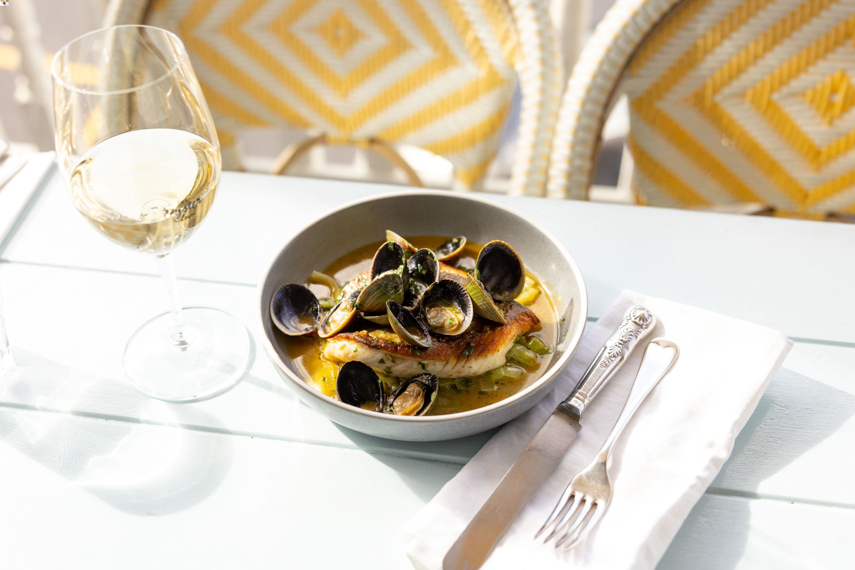 Market fish swimming in seaweed butter, from the menu at Waiheke Island's The Oyster Inn. Photo / Supplied