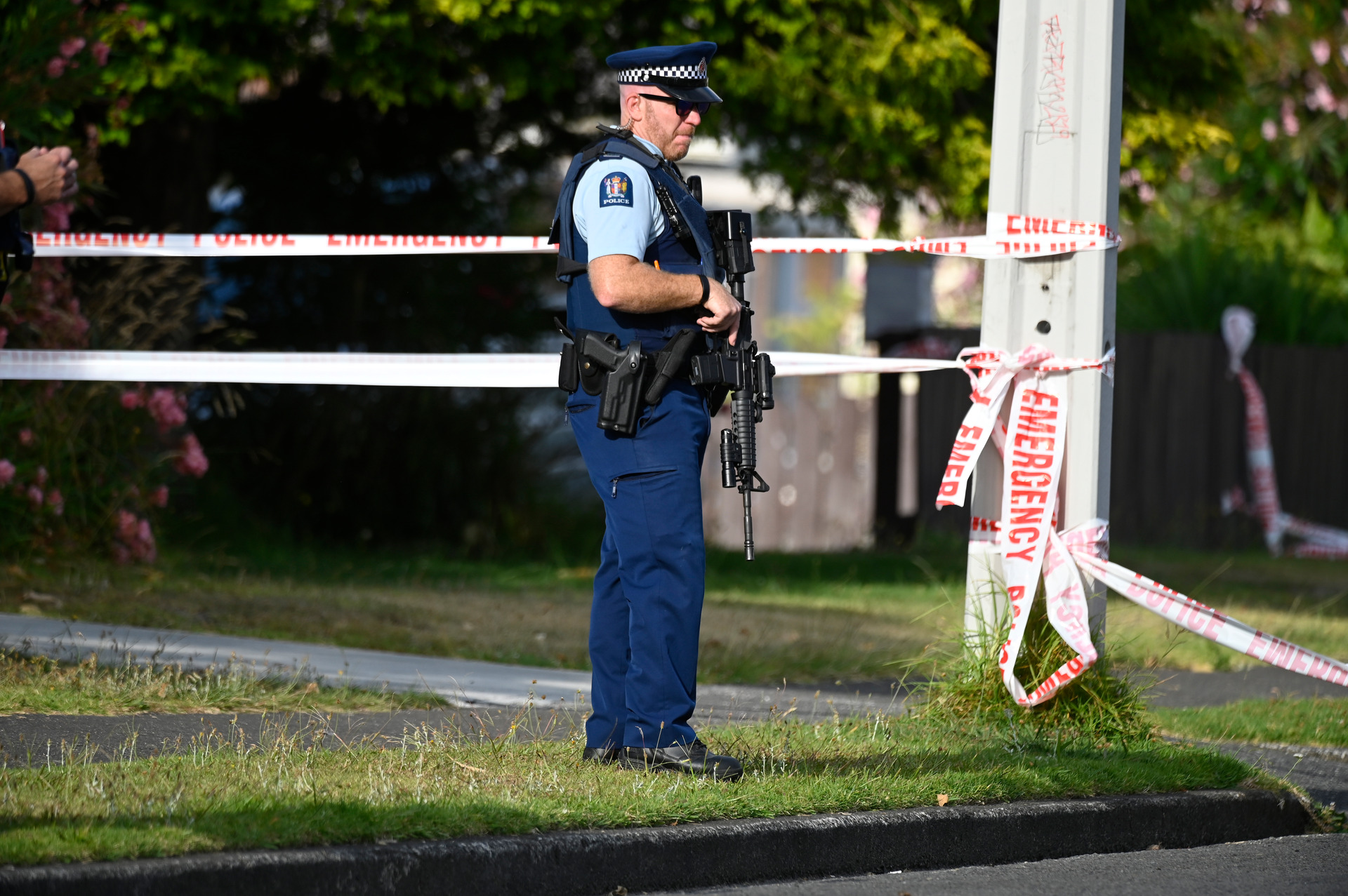 Armed police stand guard at the scene of a shooting in the Tauranga suburb of Hairini. Photo / George Novak 