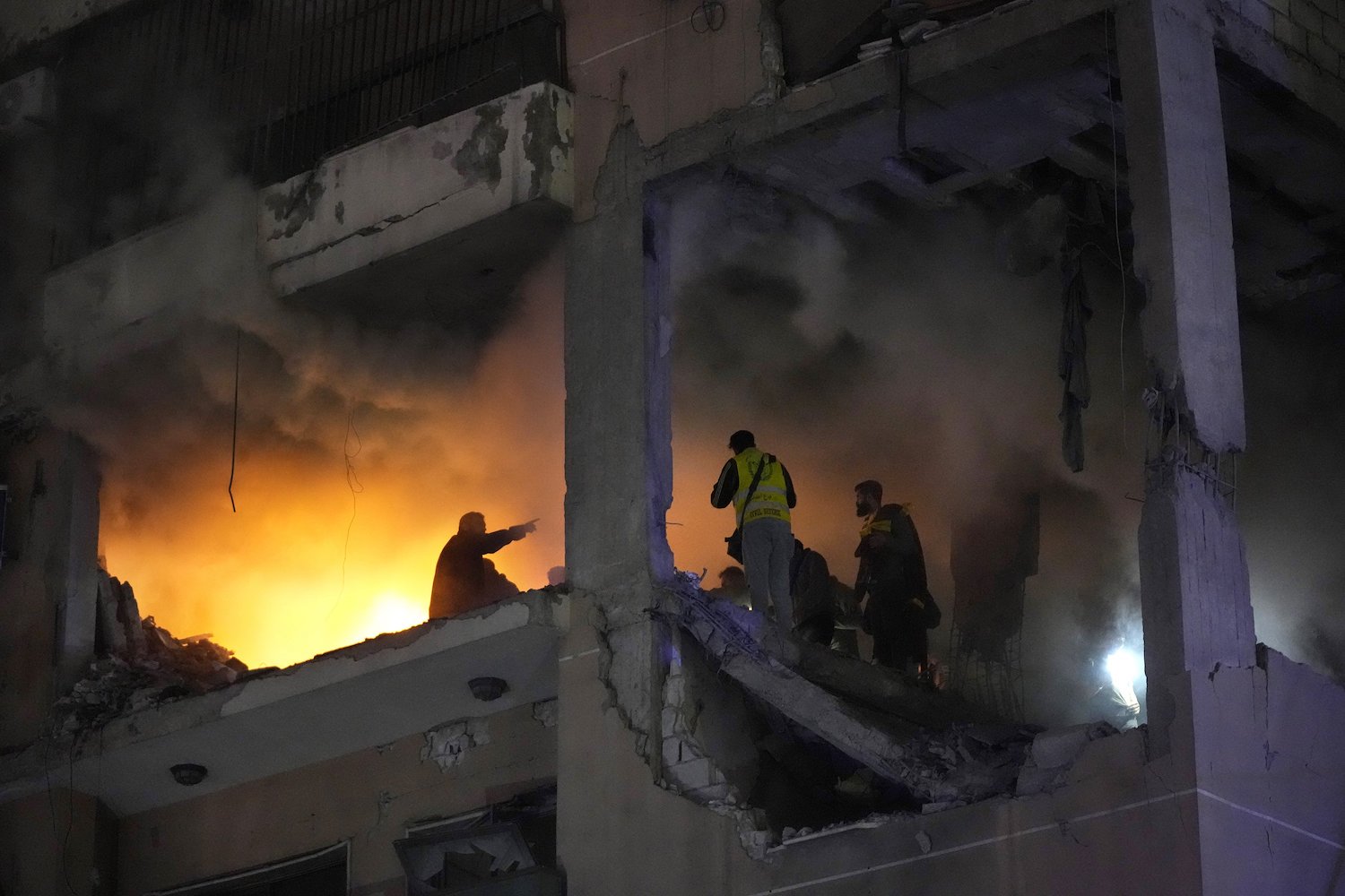 Civil defence workers search for survivors inside a destroyed apartment following a massive explosion in the southern suburb of Beirut, Lebanon. Photo / AP