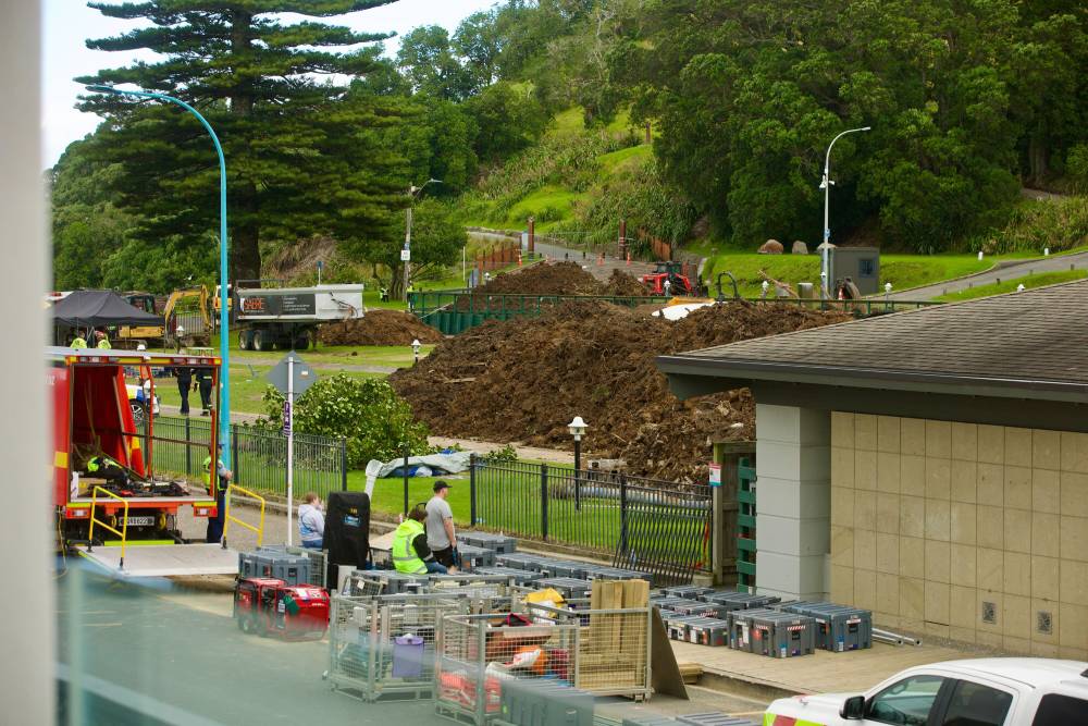 Emergency services at the Mount Maunganui Beachside Holiday Park the day after the landslide hit the campground, taking six lives. Photo / Jason Dorday