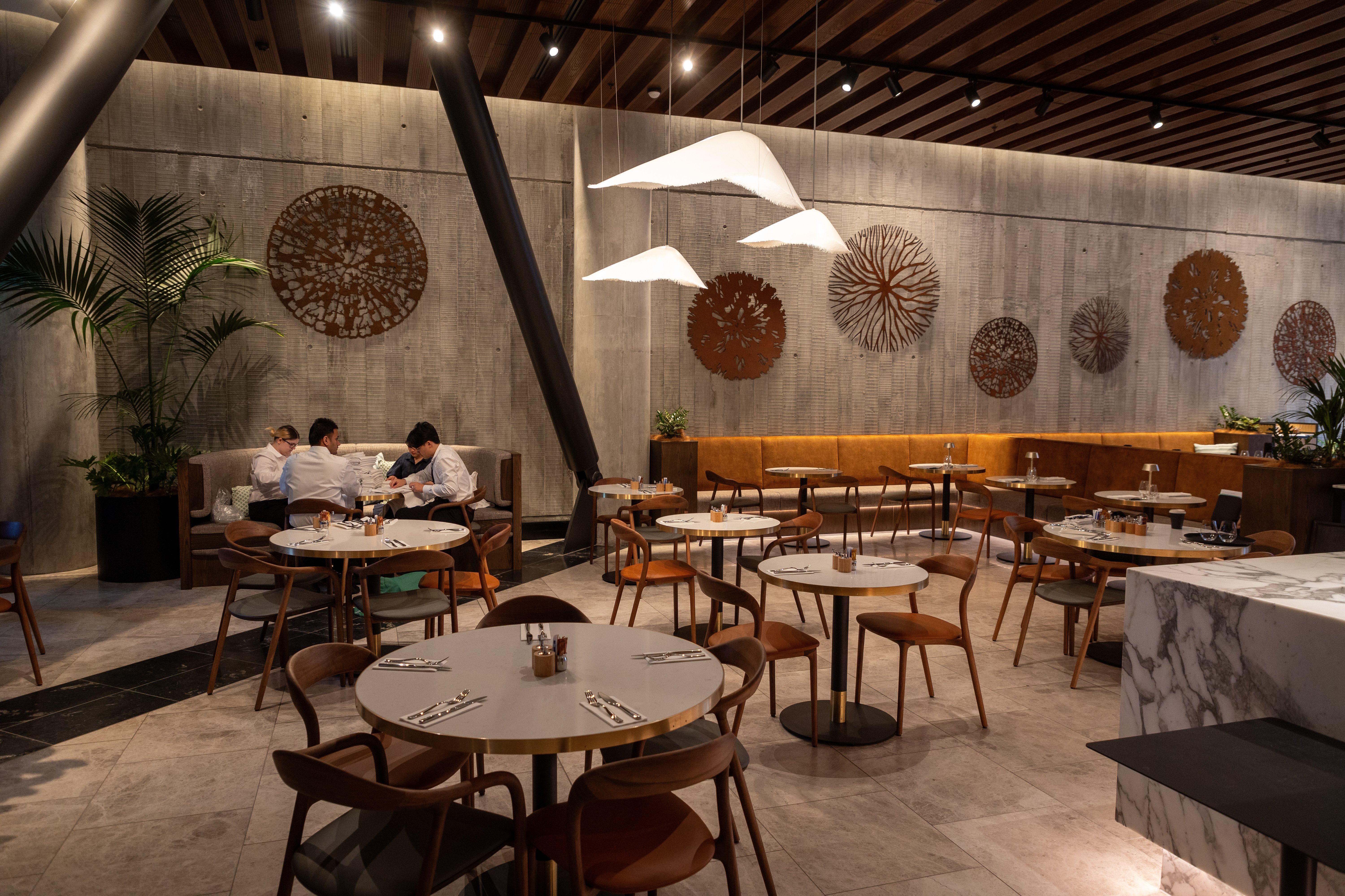 Jane Downes' artwork is on the main back wall of The Grill restaurant in Horizon by SkyCity. Matteo Ugolini's Moby Dick lights are a feature here too, a reference to the form of whales. Photo / Michael Craig