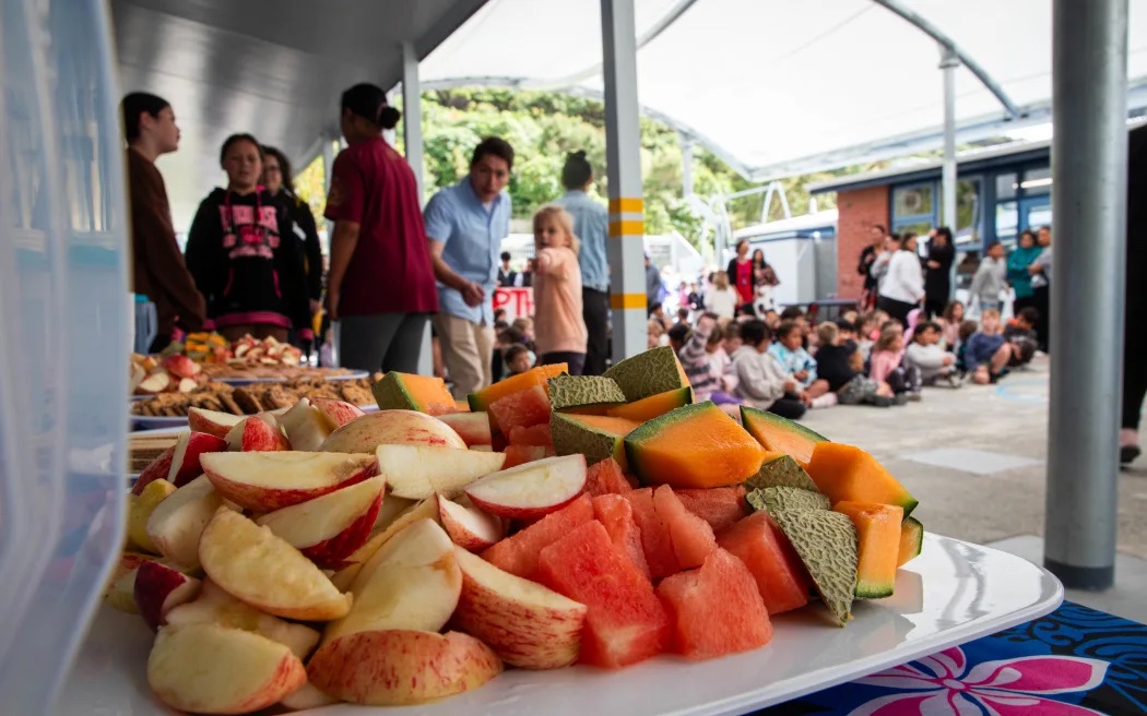 Children at Arakura School line up for free lunch. Photo  / Angus Dreaver, RNZ
