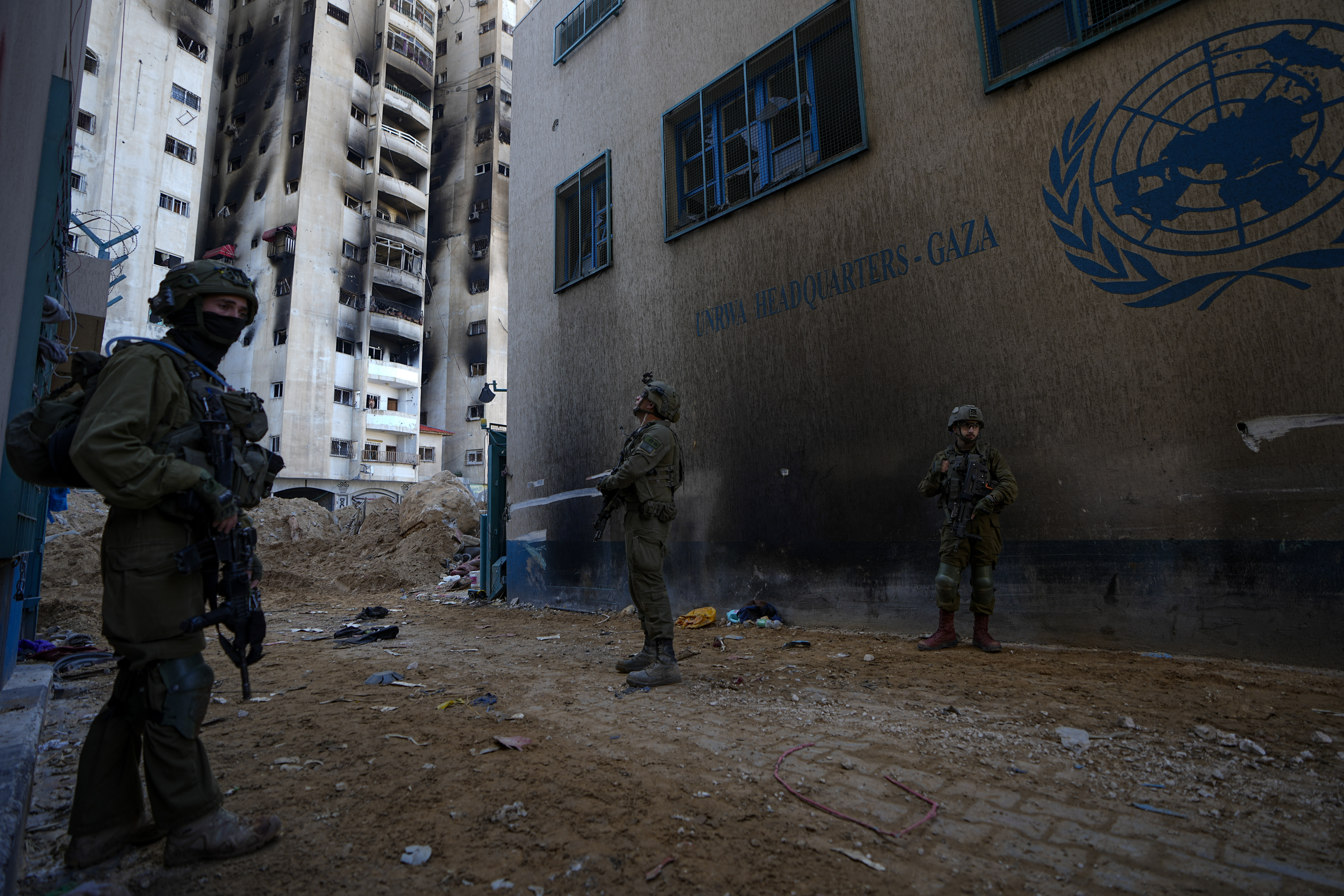 Israeli soldiers take military positions as they enter the UNRWA headquarters, beneath which the military discovered tunnels it it says Hamas militants used to attack its forces during a ground operation in Gaza. Photo / AP