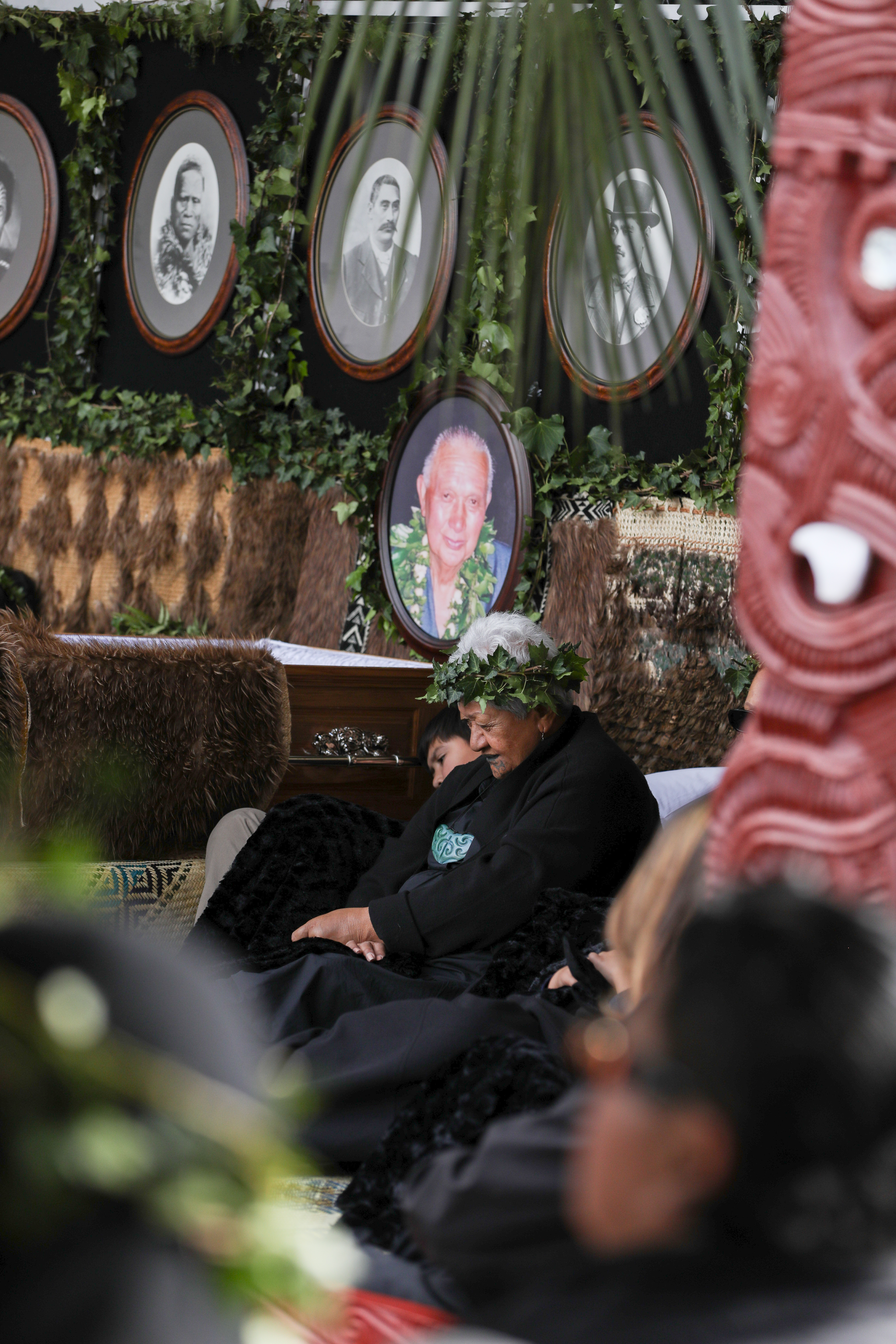 Members of Tūheitia's whānau sit alongside the Māori King's casket at Tūrangawaewae Marae in Ngāruawāhia. Photo / Kīngitanga