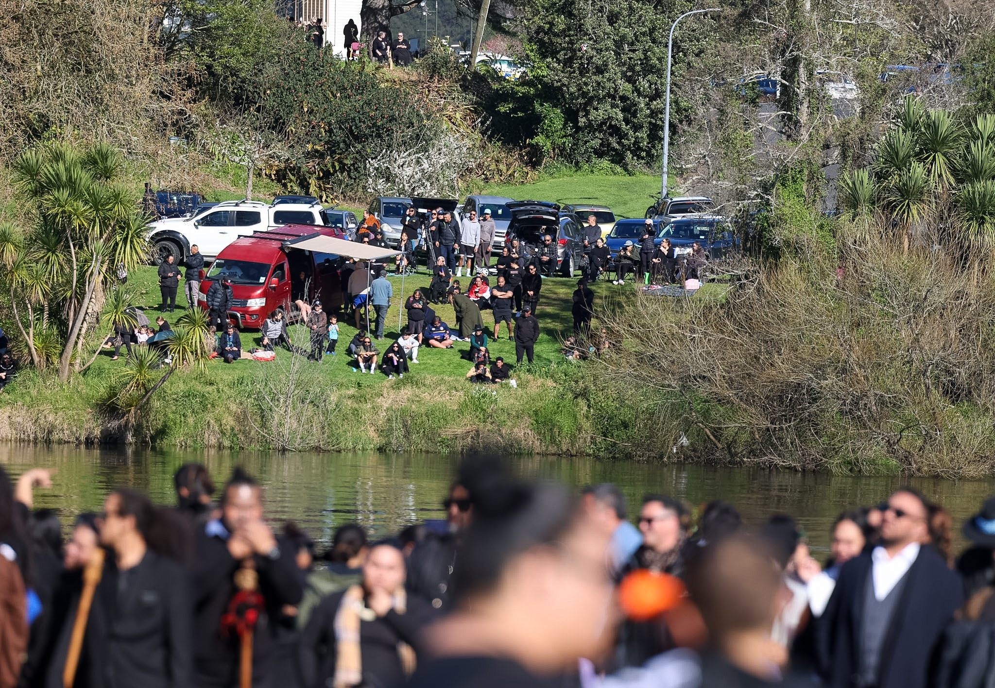 Crowds gathered on the banks of the Waikato River for the tangi. Photo / Mike Scott