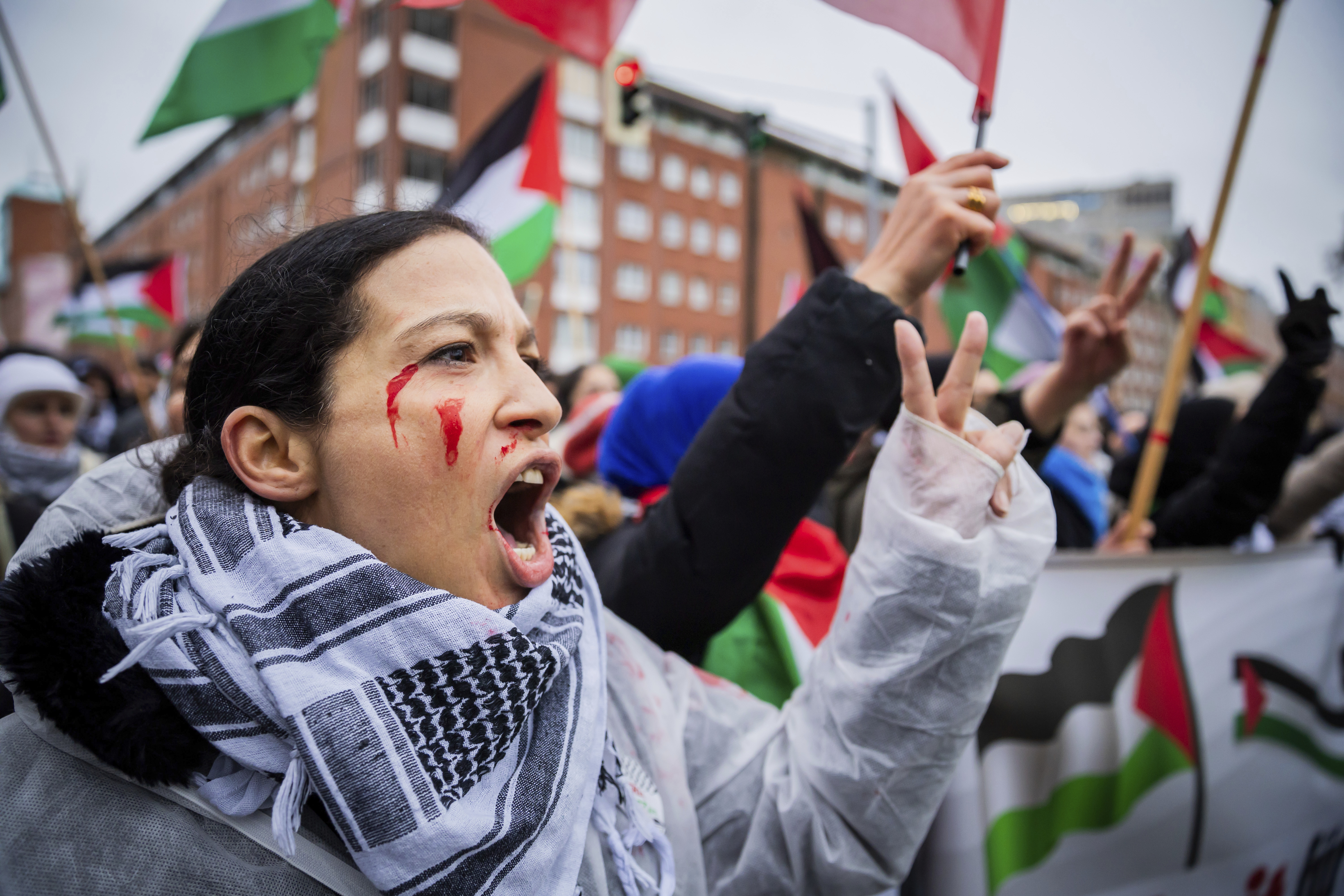 A participant chants slogans for the freedom of Gaza during a demonstration under the slogan 