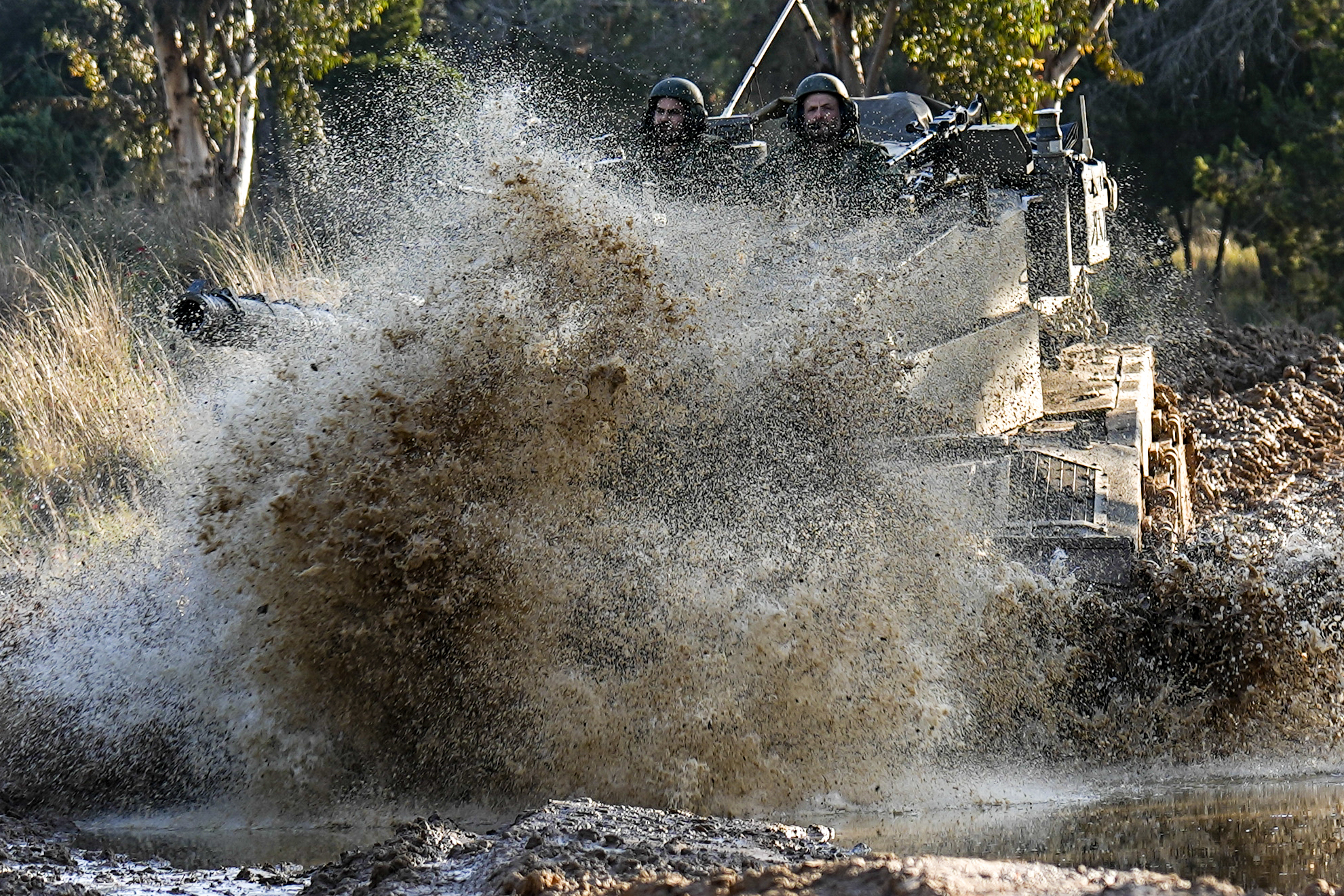Israeli soldiers drive a tank on the border with the Gaza Strip, as seen from southern Israel. Photo / AP