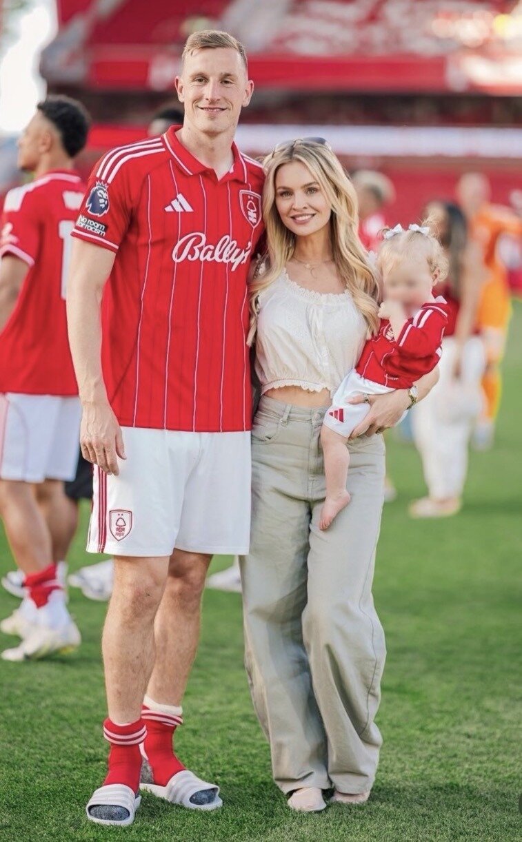 Chris and Emma Wood with their daughter Camille at Nottingham Forest’s City Ground. Photo / @Emmaaaaawood 