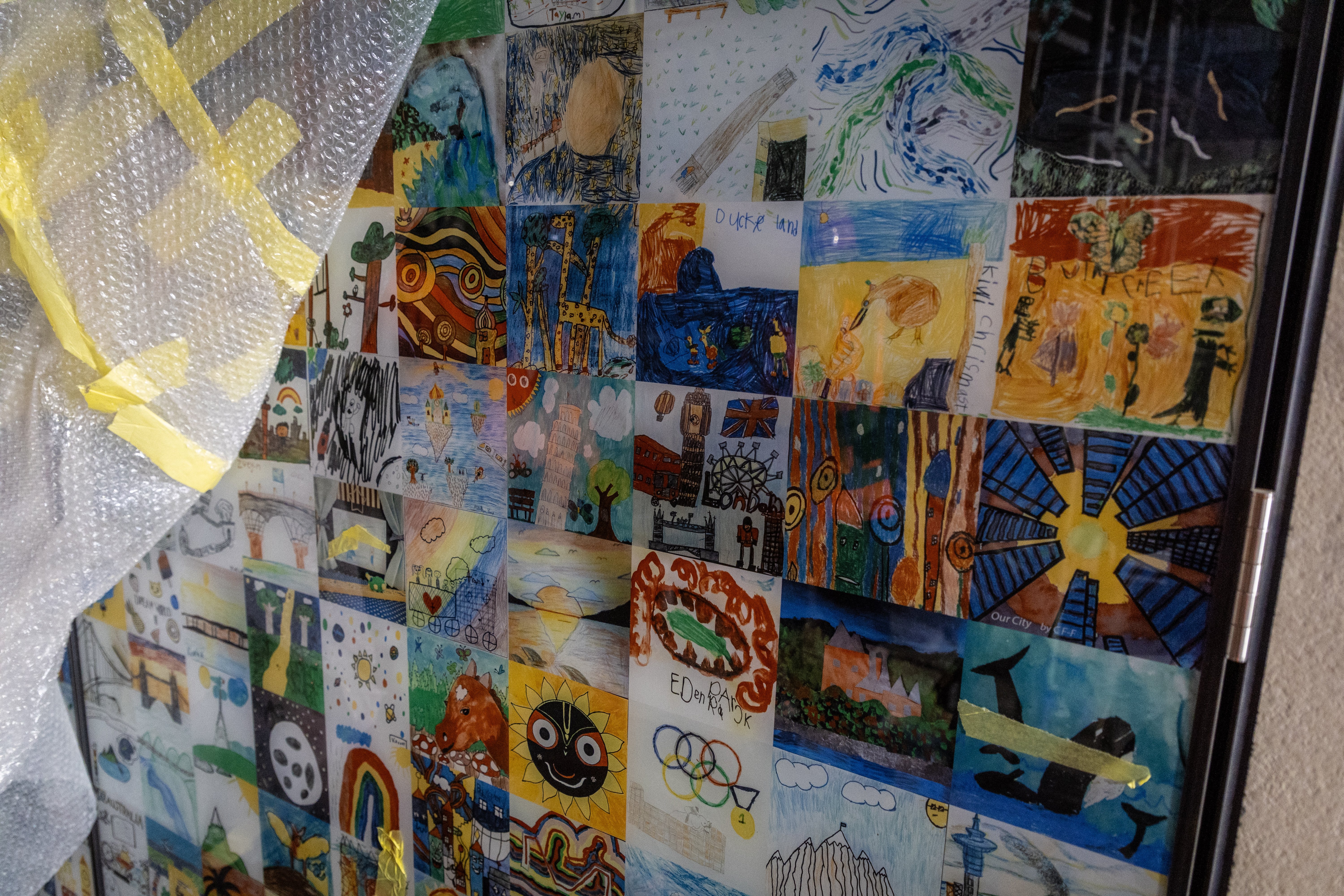 Hundreds of ceramic tiles of images drawn by children decorate a wall at the Victoria St end of Te Waihorotiu Station. Photo /  Michael Craig