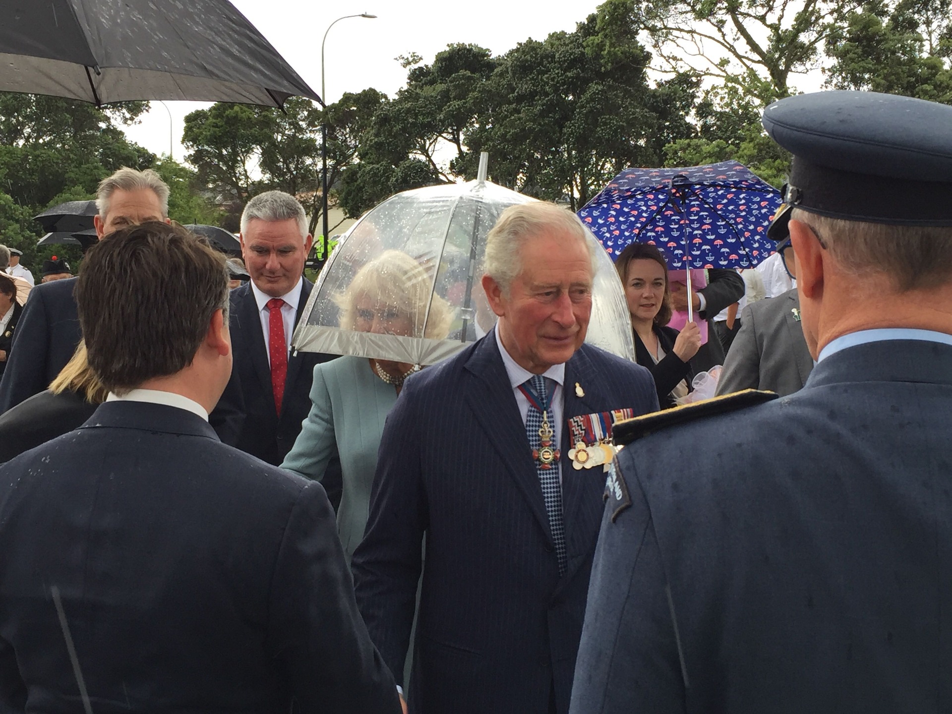Prince Charles took on the elements while his wife Camilla was handed a clear umbrella to fight off the rain. Photo / Luke Kirkness