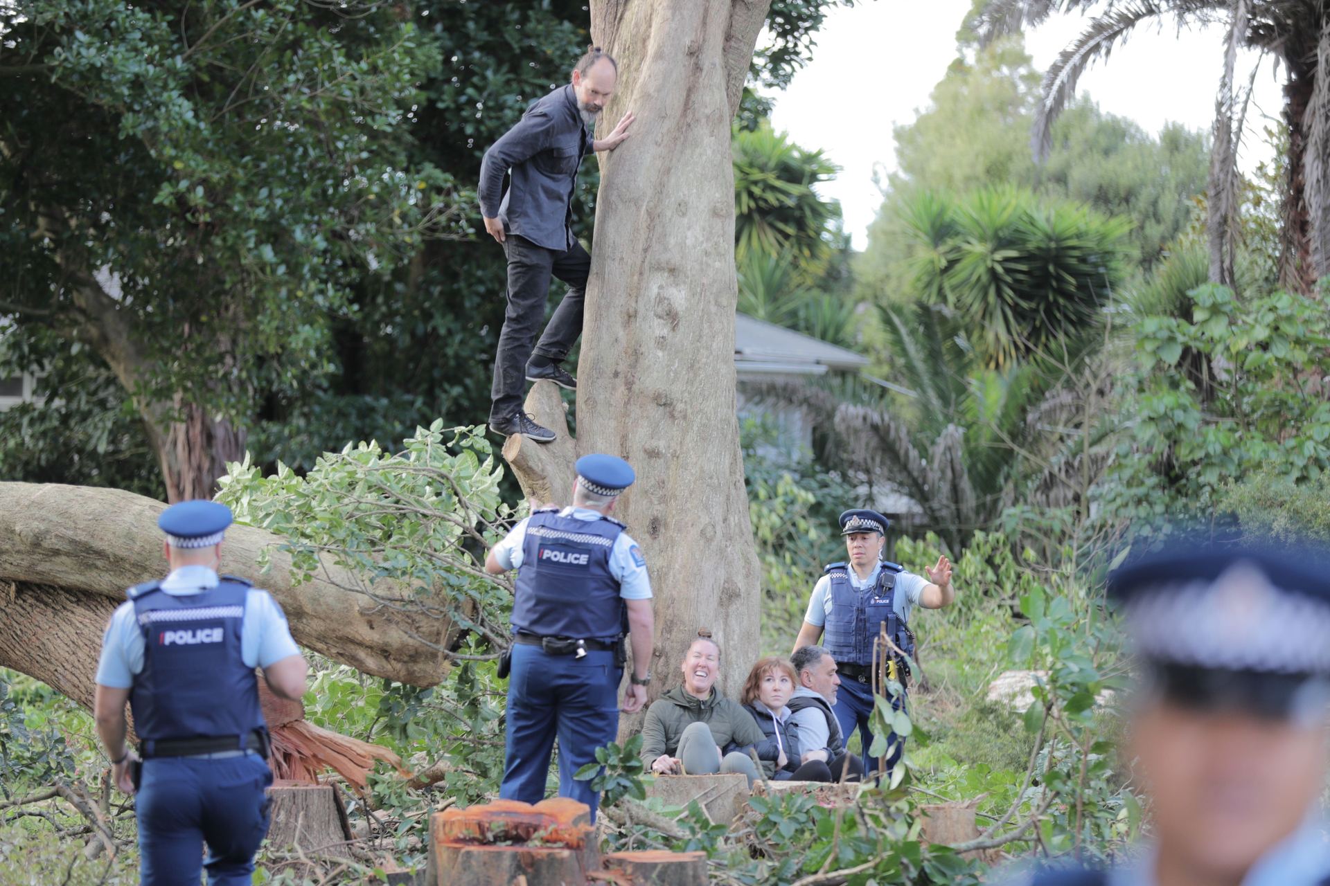 Steve Abel and other protesters this morning at the Avondale site in Auckland, speaking with police. Photo / Michael Craig