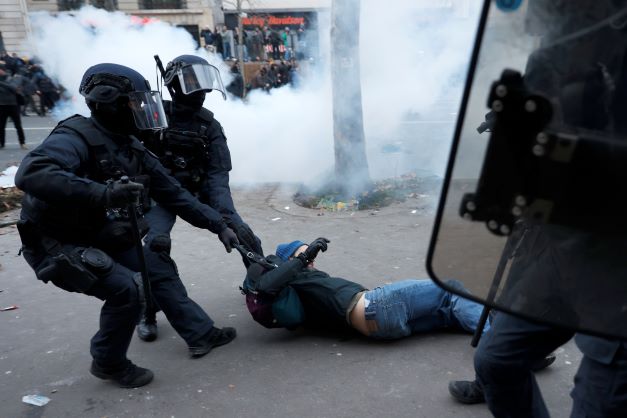 Riot police officers grab a protestor during a demonstration against pension changes in Paris on January19. Photo / AP
