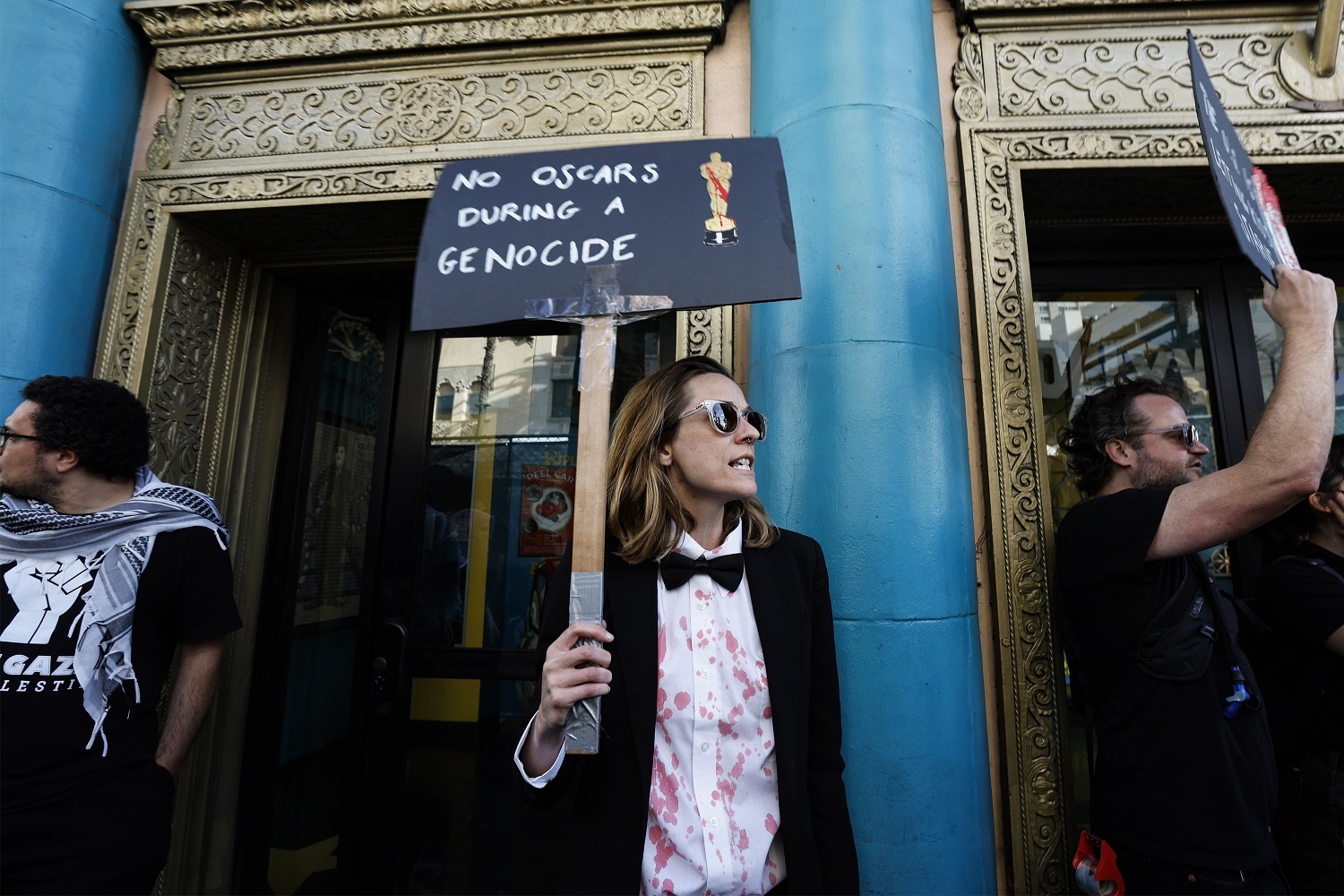 A protester holds a sign reading 