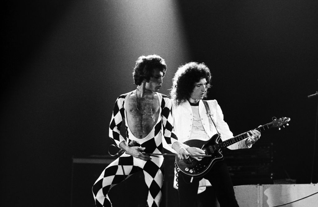 Singer Freddie Mercury and guitarist Brian May of Queen perform onstage in 1978. Freddie is wearing a harlequin one-piece, one of his most recognisable stage designs. Photo / Getty Images