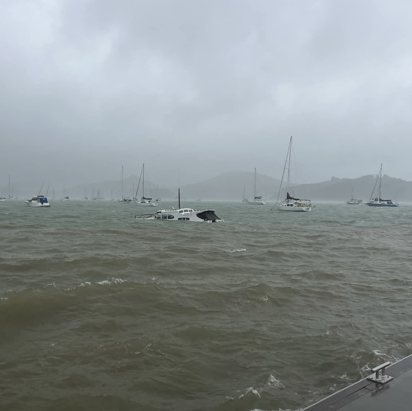 A boat appears to have sunk near the Parua Bay jetty in Whangārei. Wild winds and heavy rain battered the region overnight. Photo / Supplied