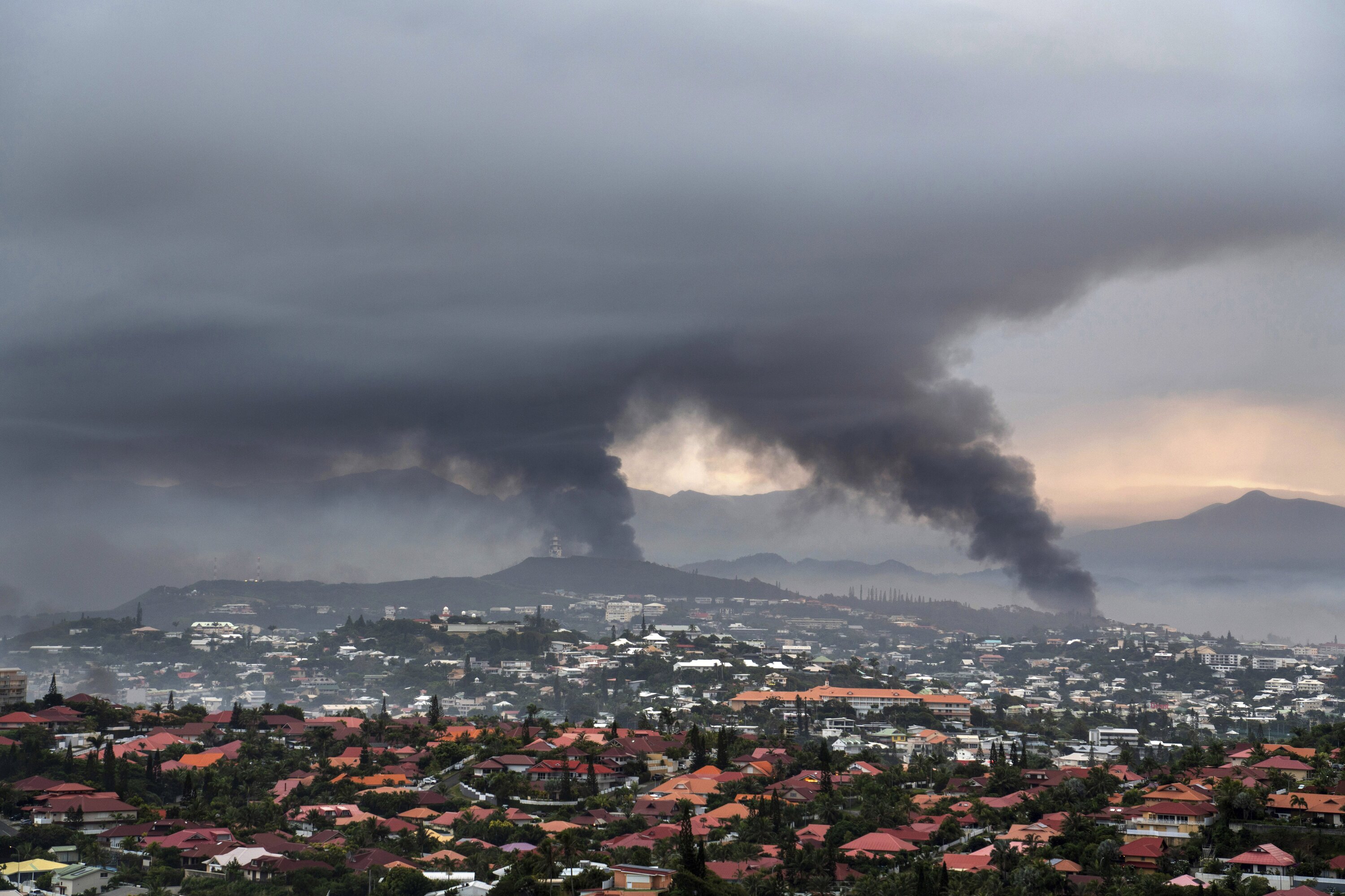 Smoke rises during protests in Noumea, New Caledonia, where France has imposed a state of emergency. Photo / Nicolas Job, AP