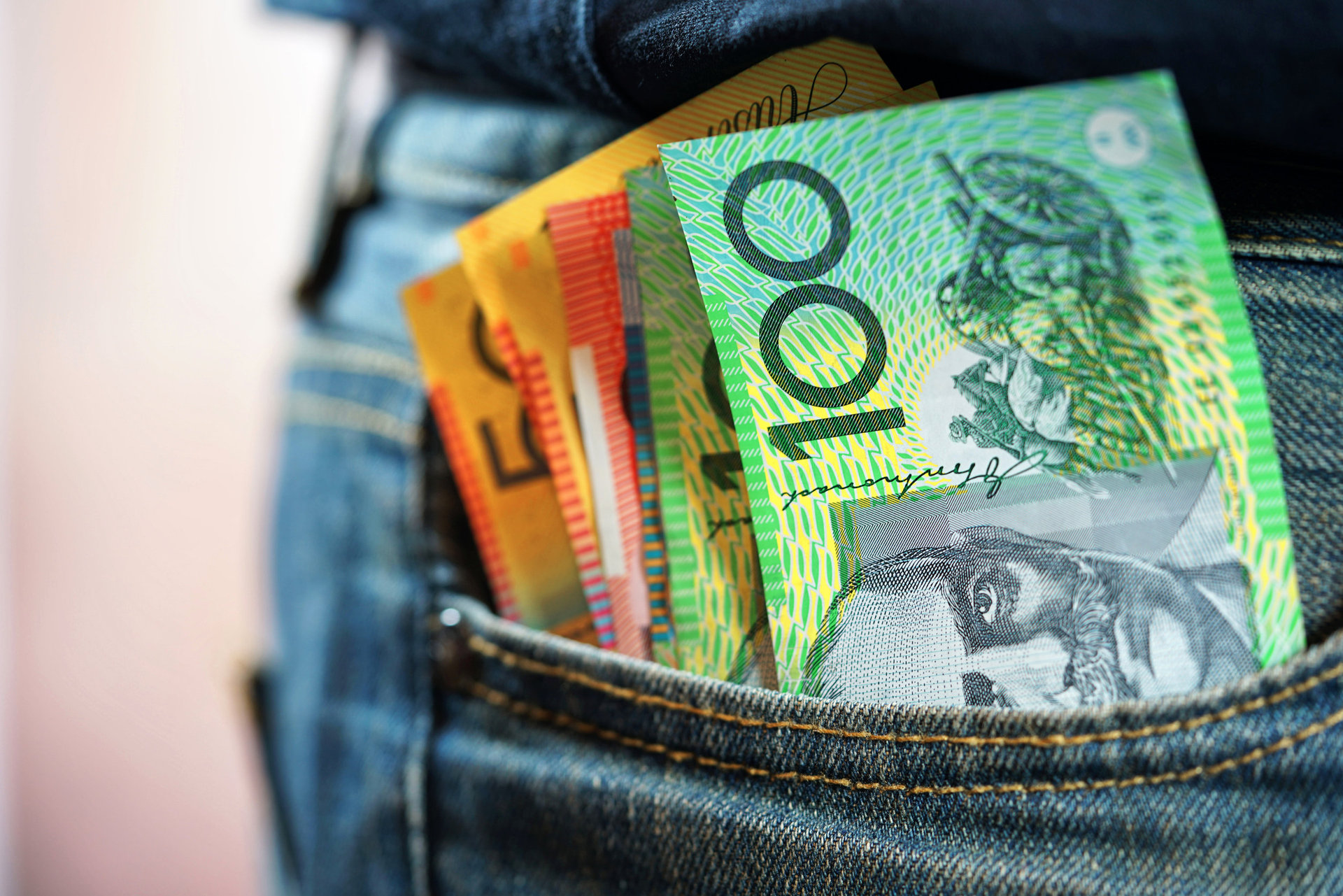 Australian cash money in mans jeans pocket, close up. 