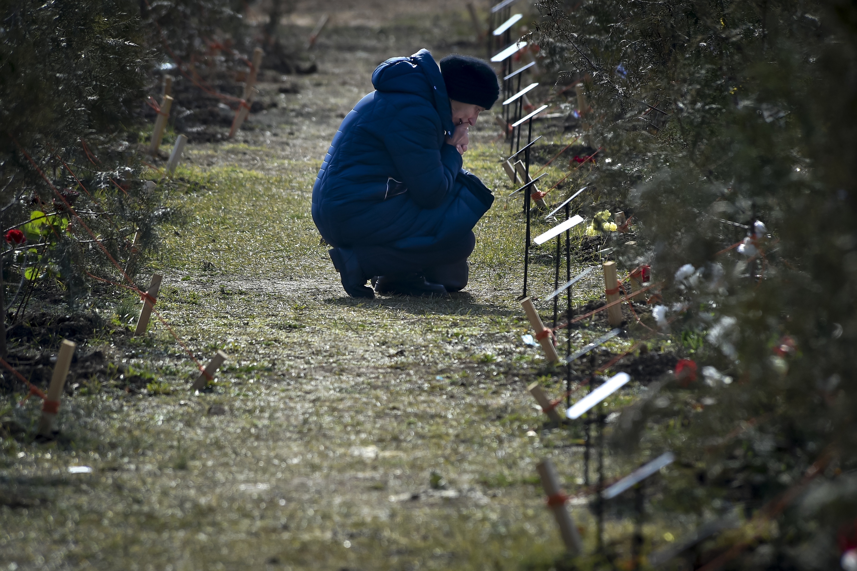 Mother of a Russian soldier who was killed in a military action in Ukraine, kneels near a planted tree in memory of her son at the Alley of Heroes in Sevastopol, Crimea. Photo / AP