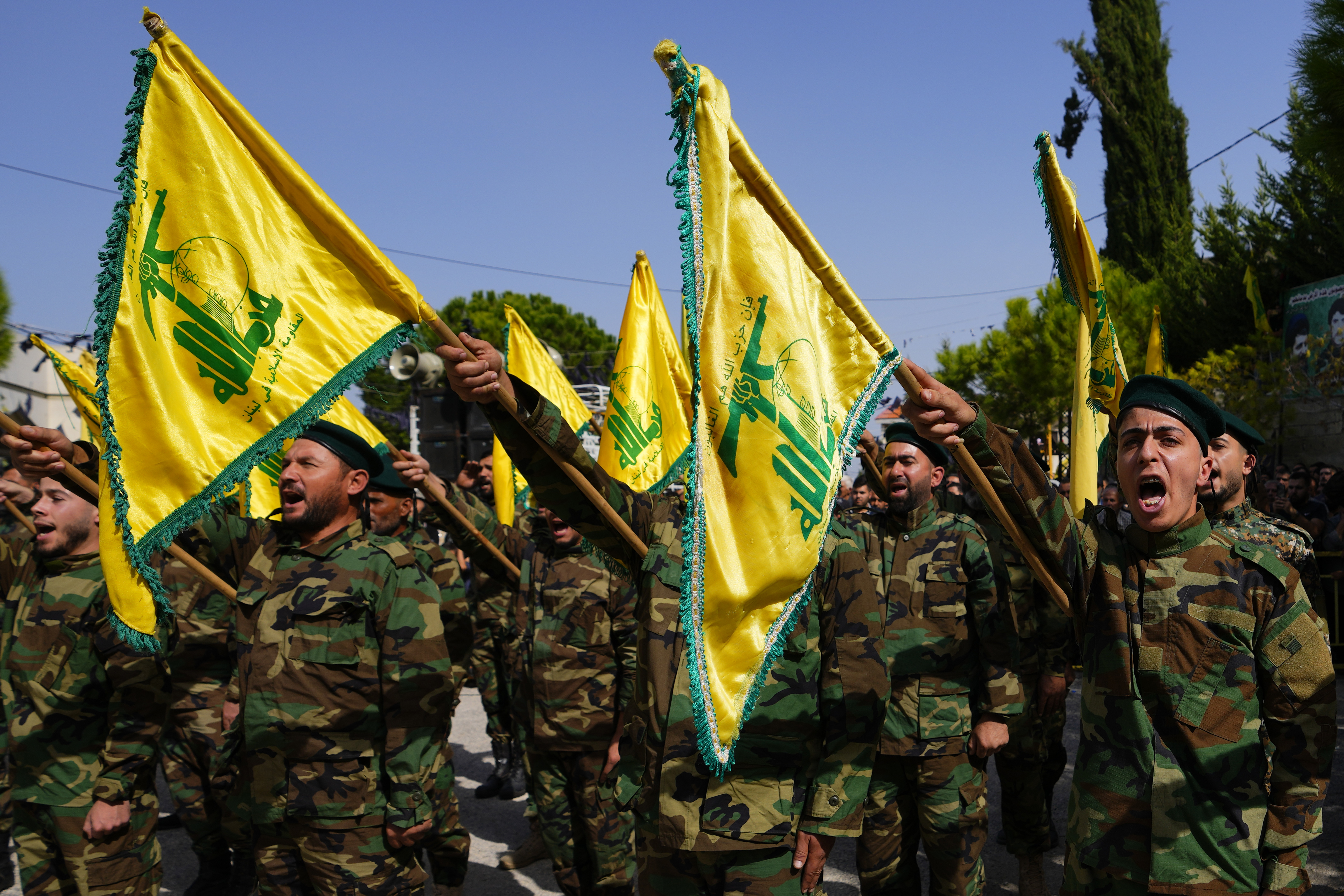 Hezbollah fighters rise their group's flag and shout slogans, as they attend the funeral procession of Hezbollah fighter Bilal Nemr Rmeiti who was killed by Israeli shelling, during his funeral procession in Majadel village, south Lebanon. Photo /AP