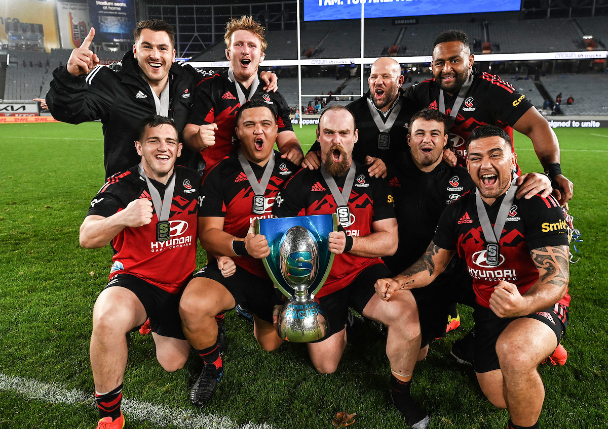 Crusaders players celebrate wearing winners' medals after the 2022 final. Photo / Photosport