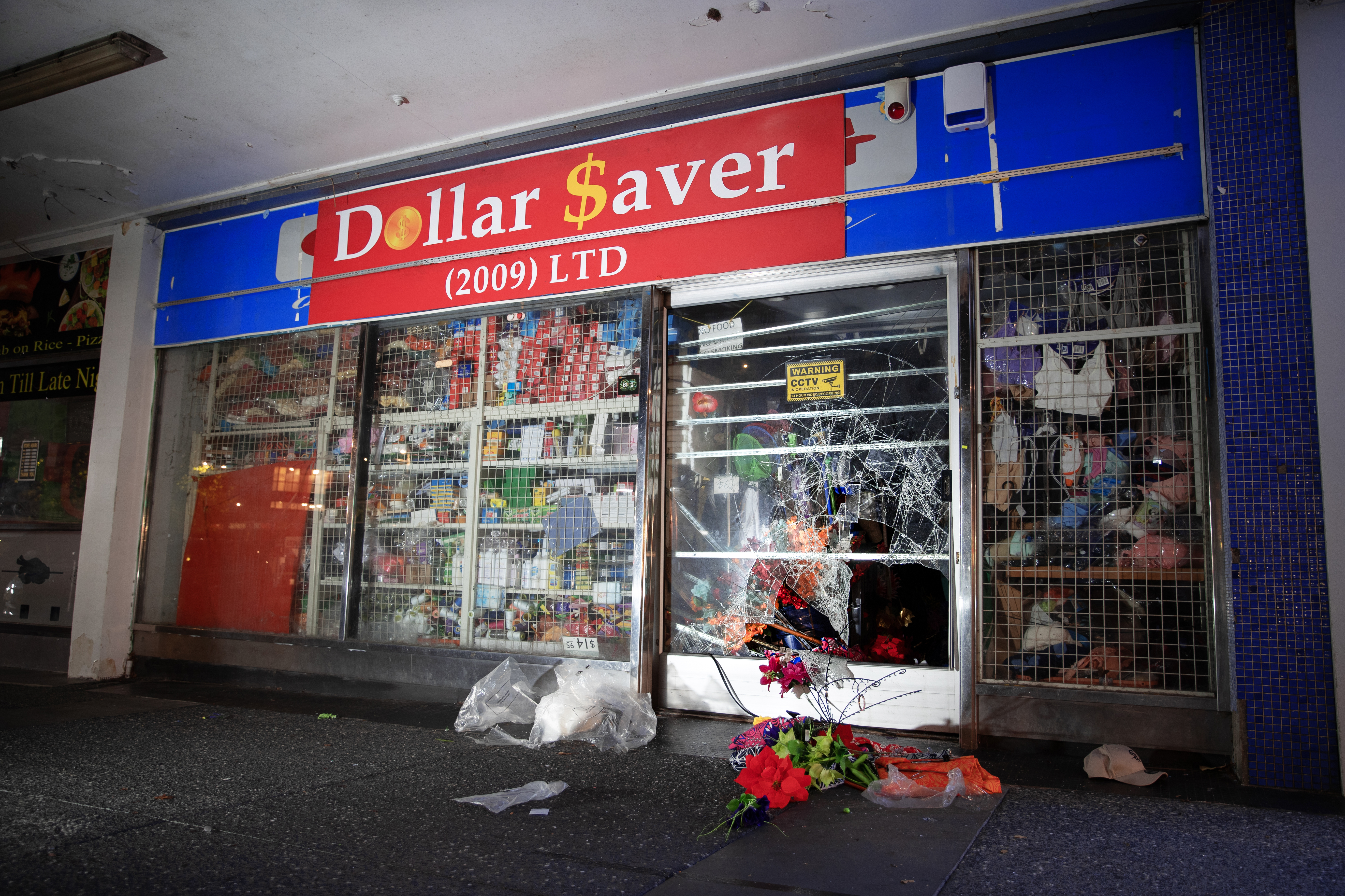 Police hunt burglary suspects after a smash-and-grab style burglary at Dollar Saver in Henderson. Photo / Hayden Woodward
