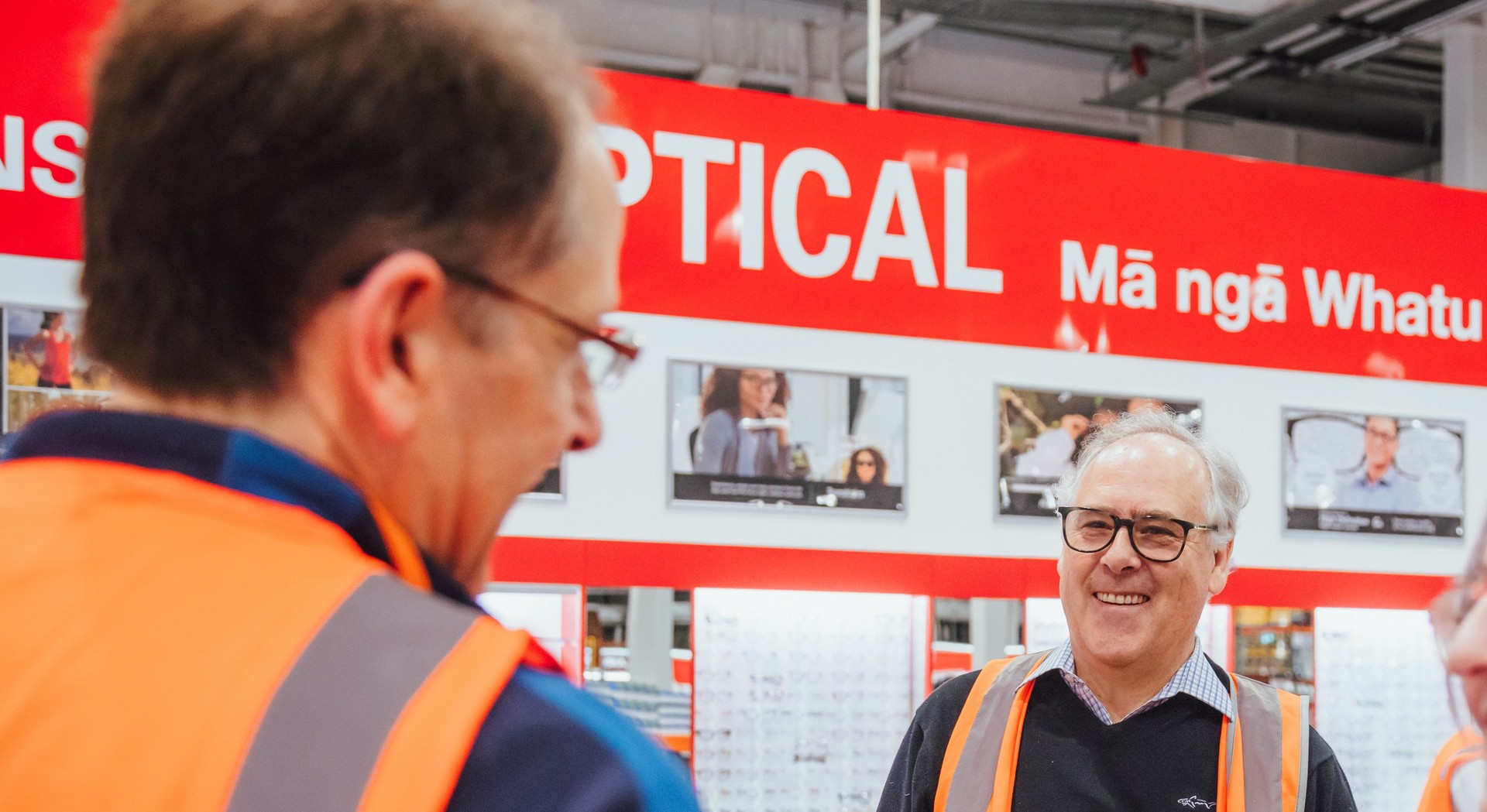 Noone (right) in the new store in front of one of the bilingual signs. Photo / supplied