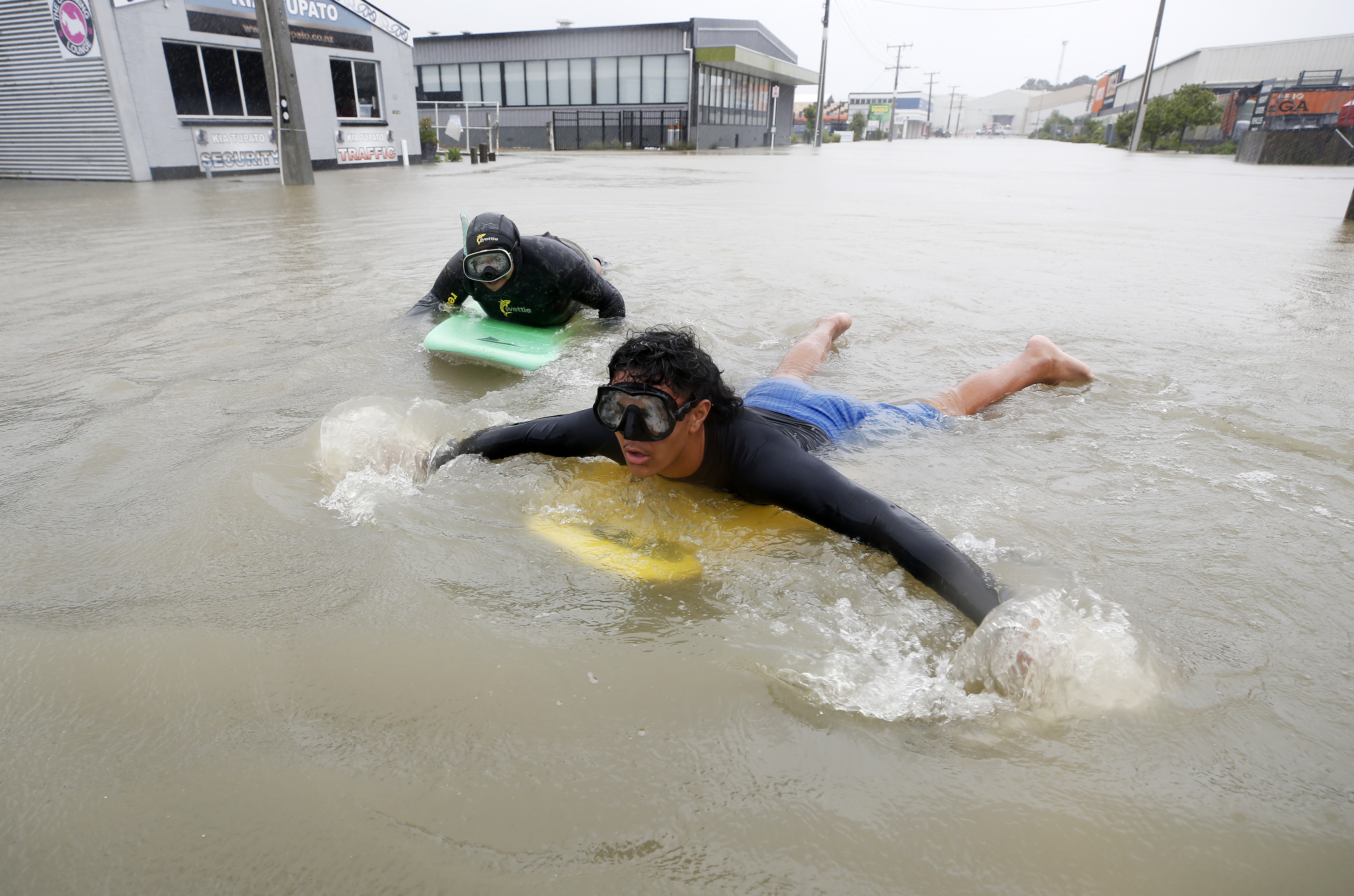 Dejay Ellis (back) and Innocent Tuimavave, make the most of the flooding on Kaka St. Photo / Michael Cunningham