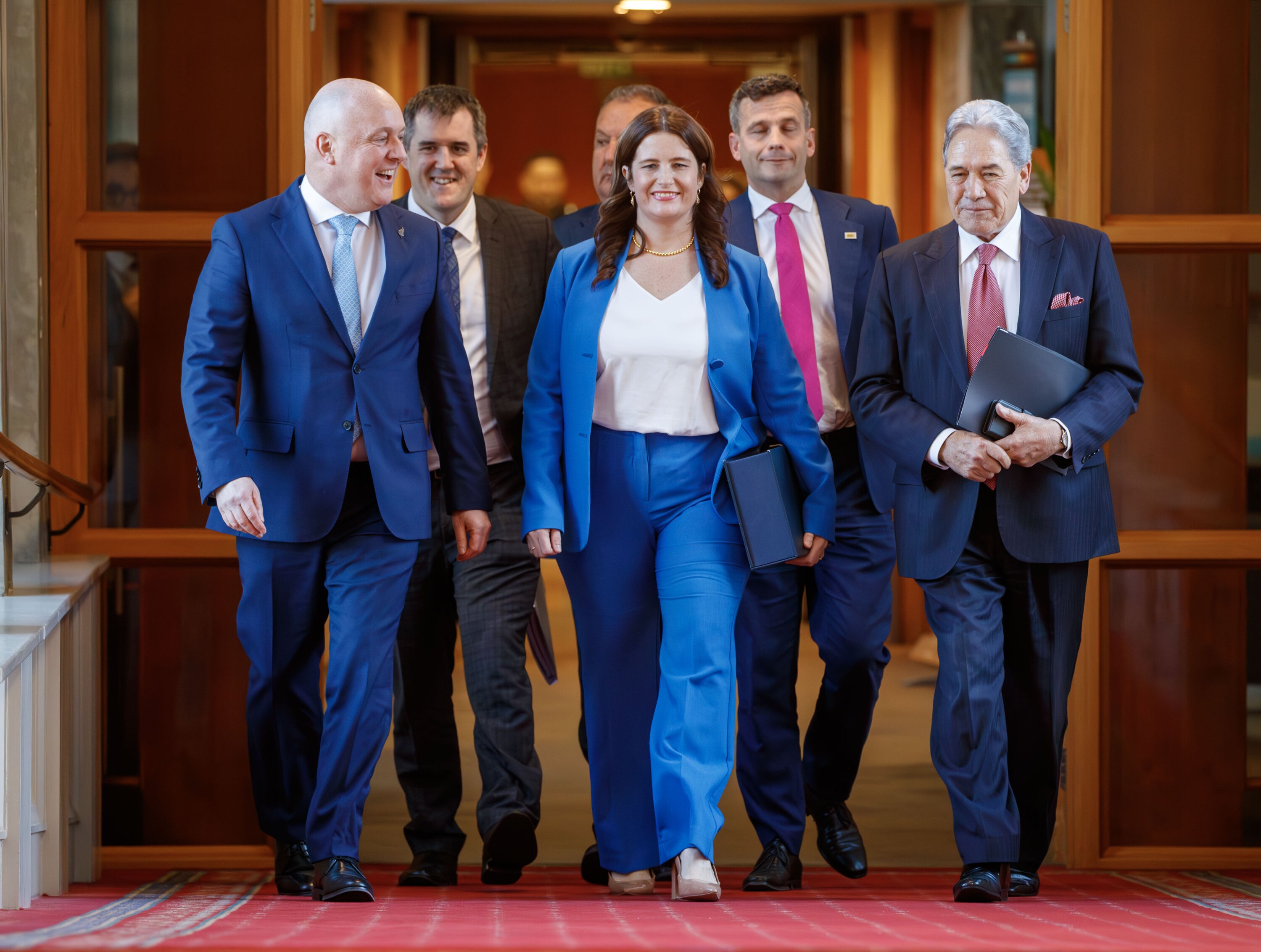 Prime Minister Christopher Luxon, Finance Minister Nicola Willis and Deputy Prime Minister Winston Peters head to the Parliamentary debating chamber to deliver the coalition Government's first Budget. Photo / Mark Mitchell