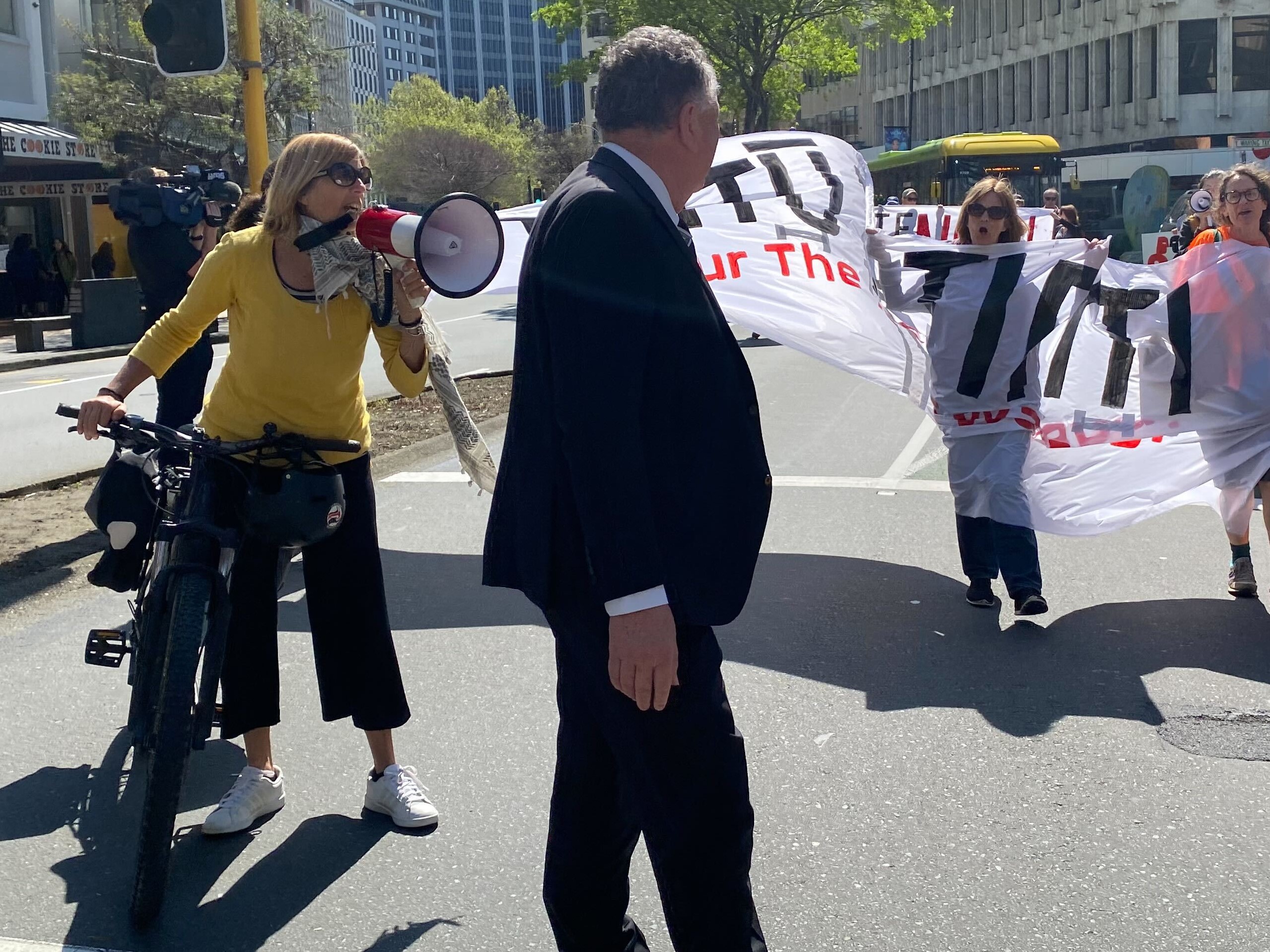 Valerie Morse (left), and other protesters from Oil Free Wellington shouting at Resources Minister Shane Jones on Monday. Photo / Azaria Howell