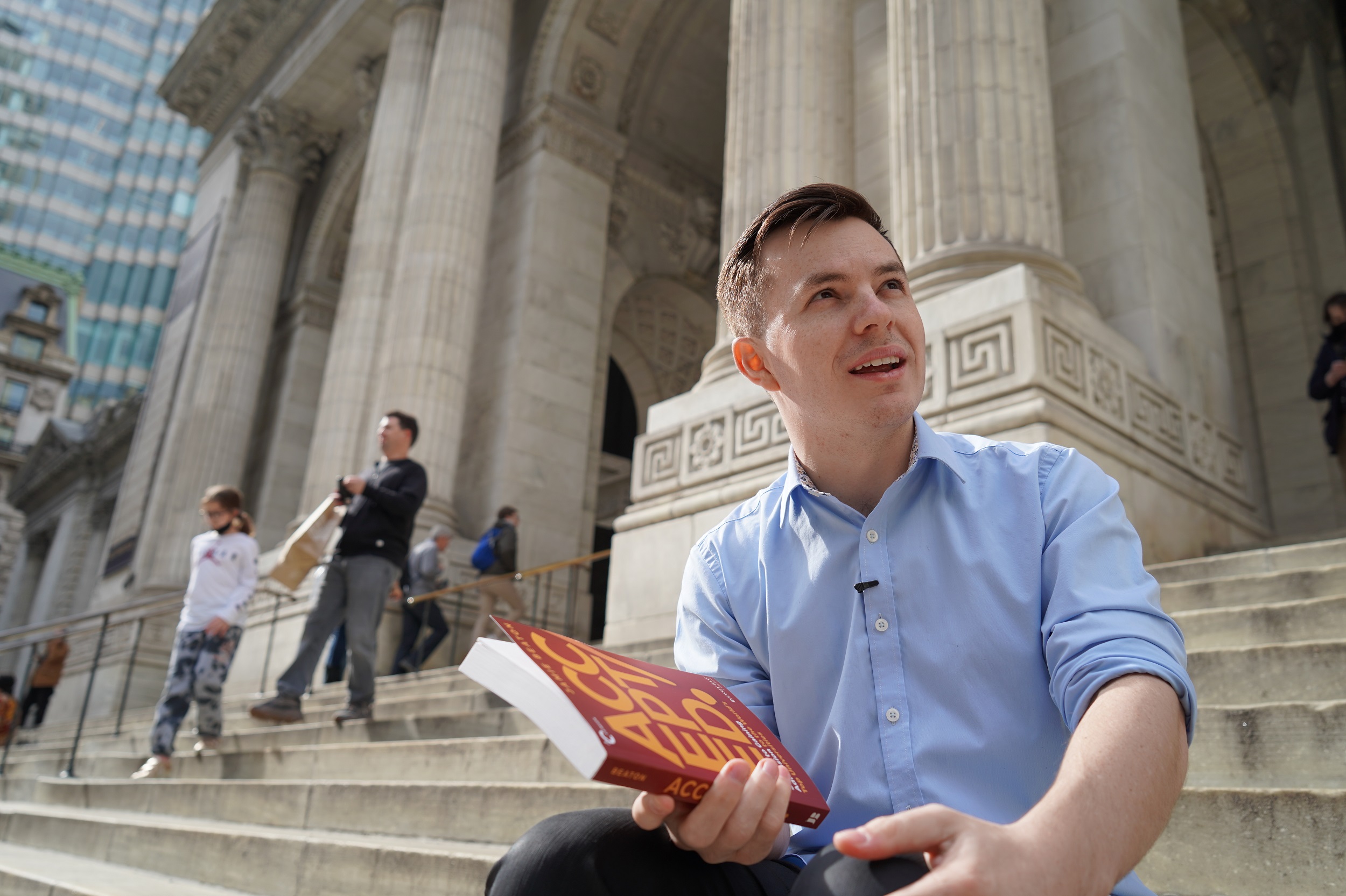 Jamie Beaton in Manhattan with a copy of his first book, Accepted.