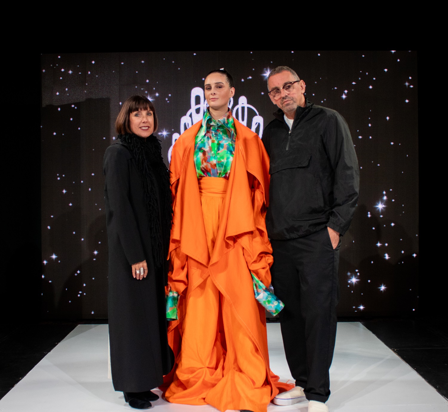 Judge Vicki Taylor from Taylor Boutique with Huffer co-founder Steve Dunstan with a winning design by Tegan Rose Vickery, worn by model Olivia Earl. Photo / Max Bolloch