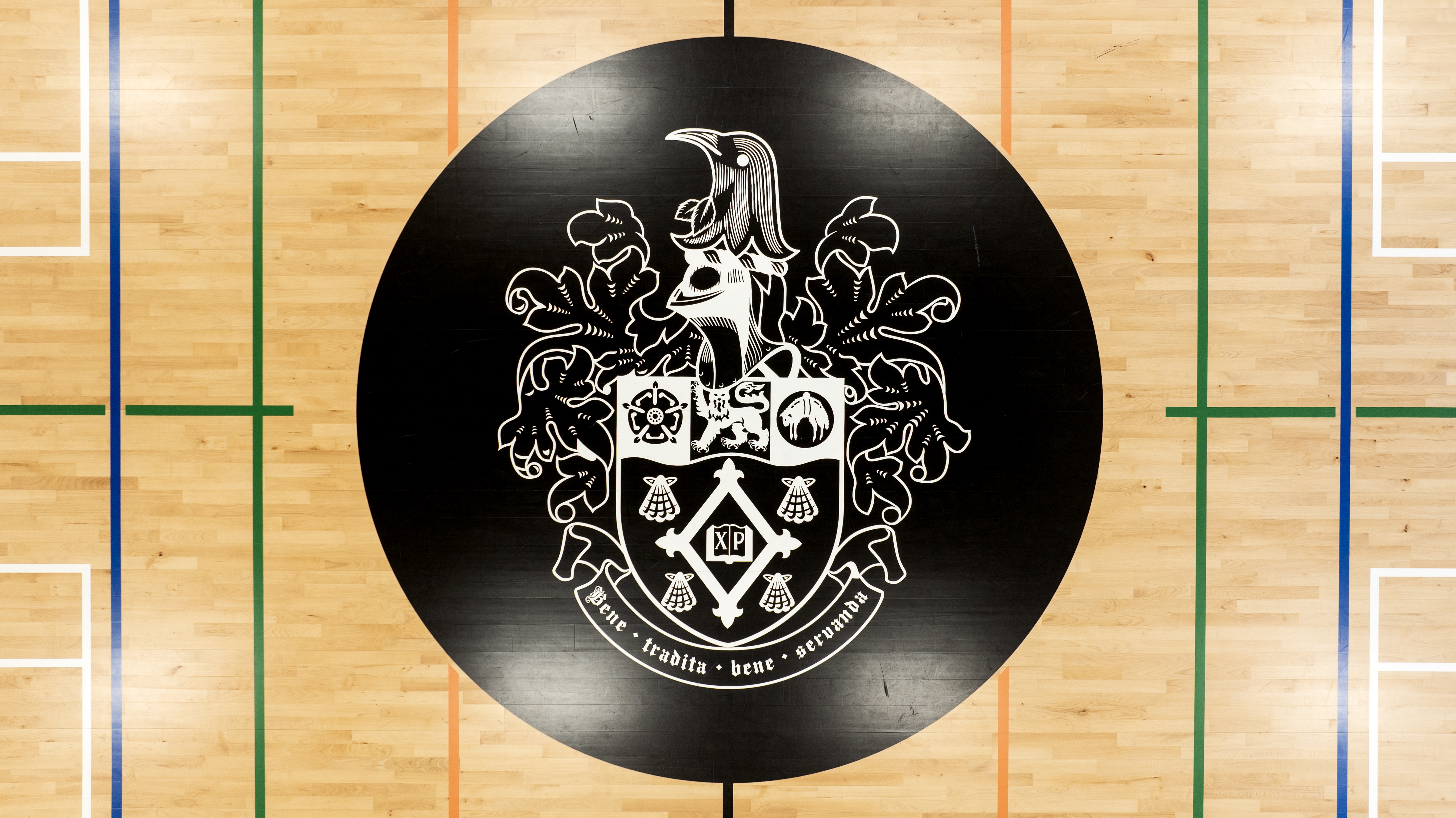 The Christ's College crest adorns the floor of Hickman Gymnasium, marking the halfway line of the feature court. Photo / George Heard